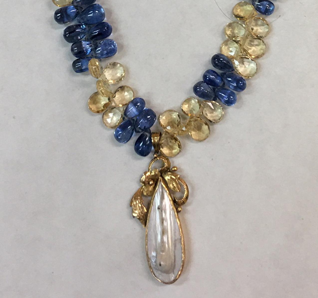 Fabulous Art Nouveau Free-form Teardrop Pearl in 14k yellow gold handmade mounting of floral/foliage design accompanied by cabochon teardrop Pearl; necklace comprised of facet-cut citrine and sapphire briolettes, held by an 18k yellow gold clasp