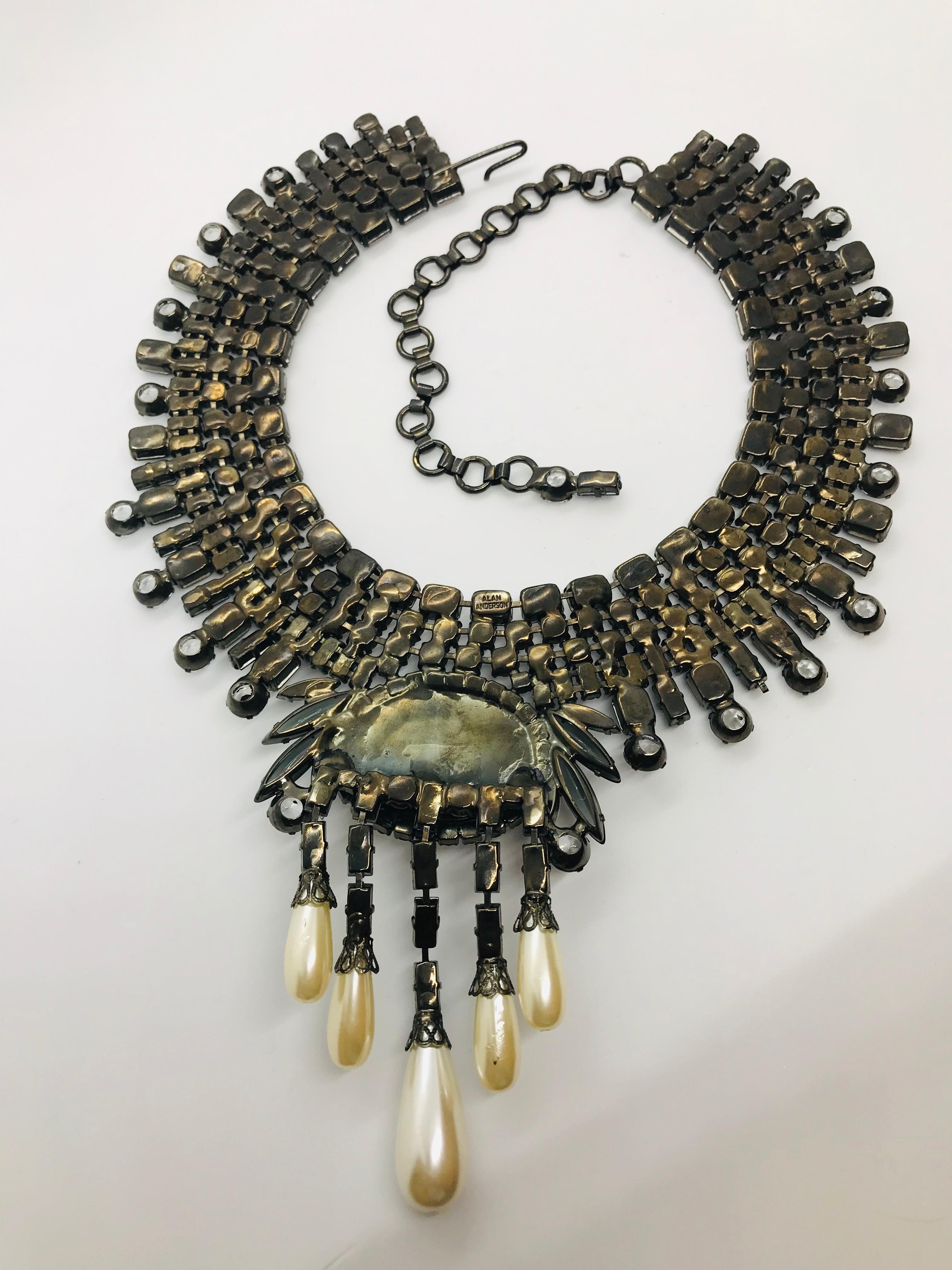 Reminiscent of some of the necklaces produced by the great jewelry houses of the early 20th century this sapphire and clear Austrian crystal mauvé pearl fringed collar necklace captures the period perfectly!  The necklace centers on a medallion with