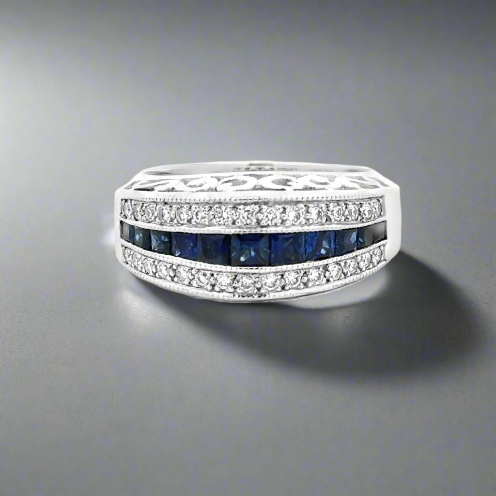 Introducing our elegant Sapphire and Diamond 14k White Gold Band/Ring. Boasting over one carat each of sapphires and diamonds, this heavy duty band features intricate scrollwork. Elevate any ensemble with this luxurious and expertly crafted piece of