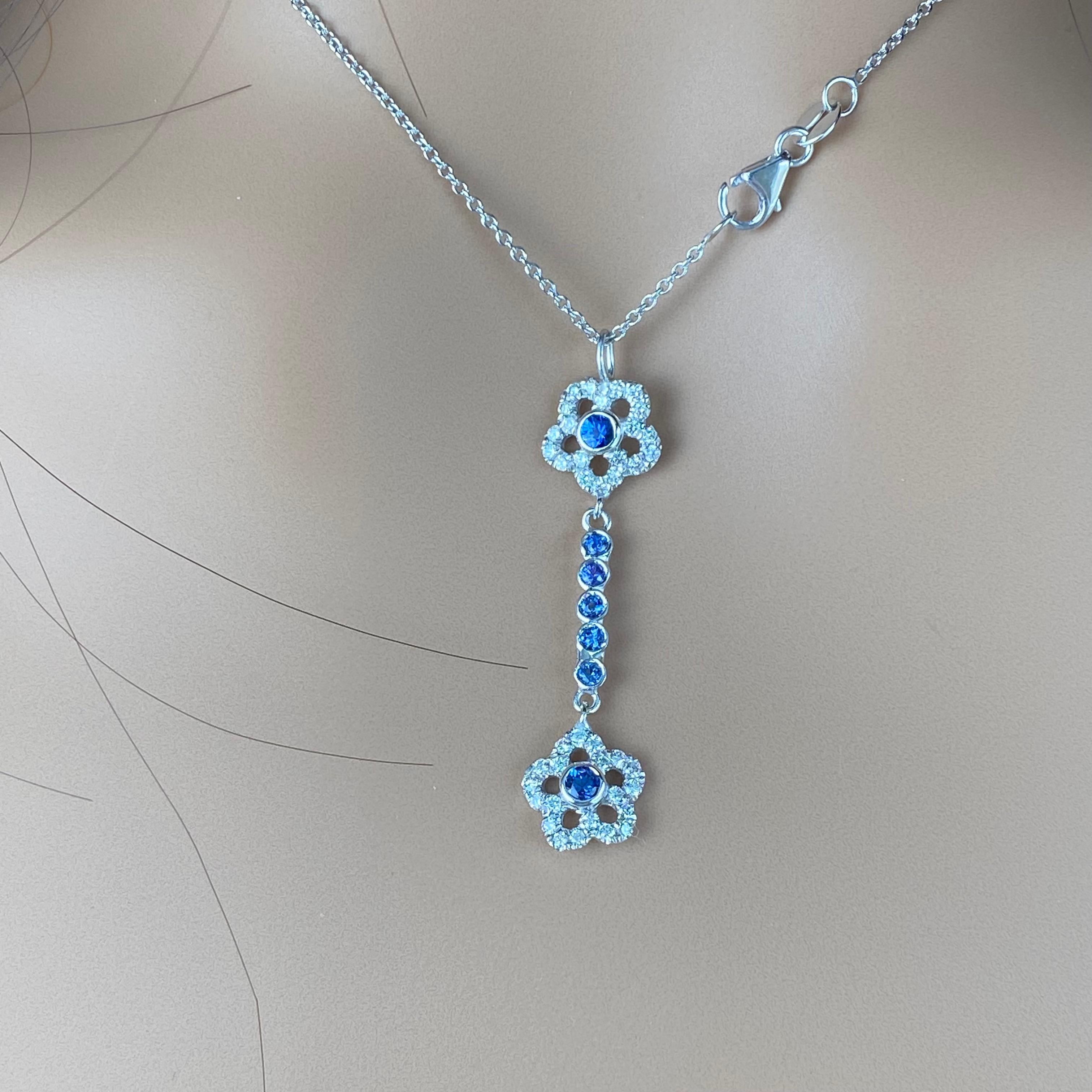 Introducing our exquisite 14 karat white gold lariat drop necklace, an epitome of elegance and sophistication. Crafted with meticulous attention to detail, this stunning piece features a captivating floral design embellished with lustrous sapphires