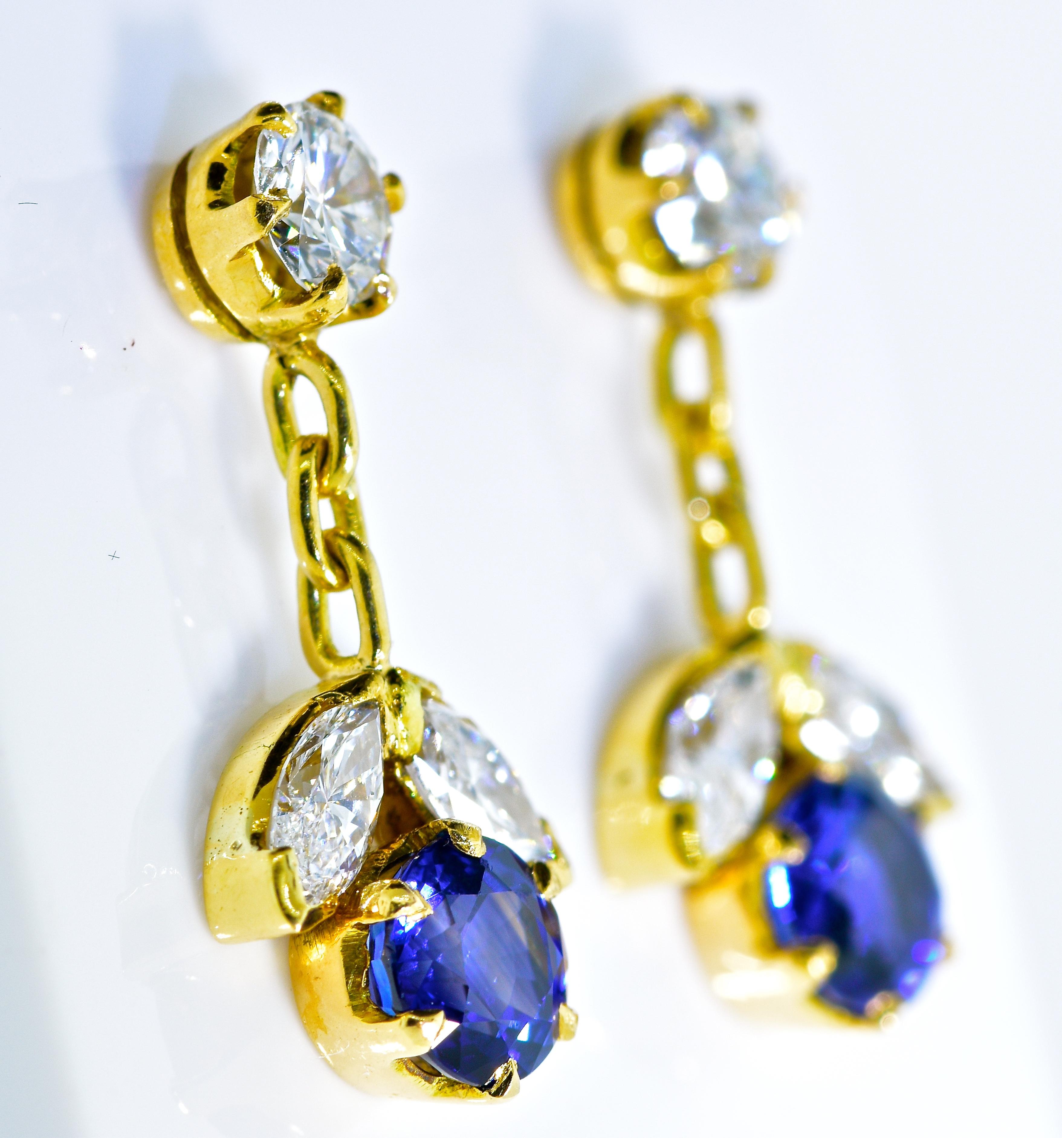 Diamond and sapphire earrings, the vivid blue natural sapphires display excellent color and are well matched.  They are estimated to weigh 1.0 cts. totally.  The round brilliant cut and marquis cut diamonds are very white and of very fine quality. 