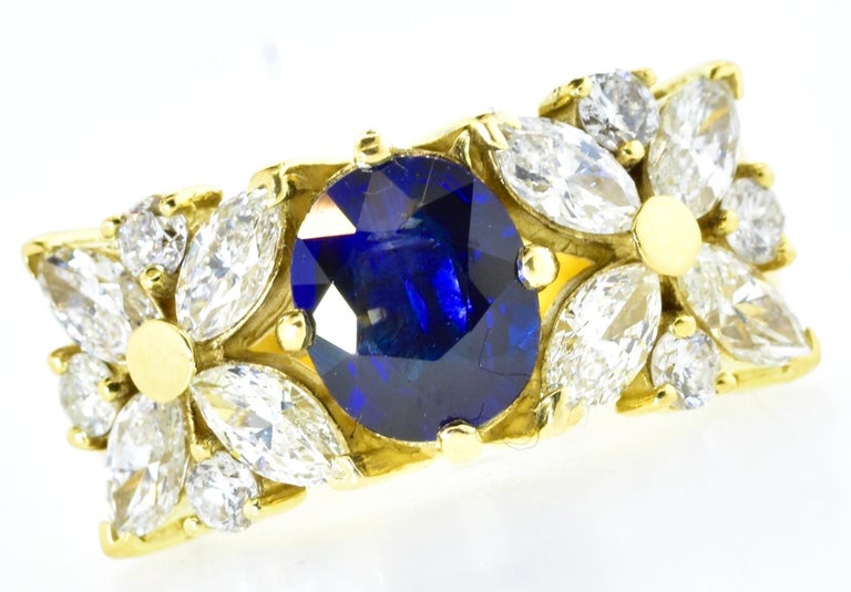Diamond and sapphire 18K yellow gold ring.  The fine white diamonds are both round brilliant cut and marquis cut.  The diamonds average H (near colorless), and VS1 (very slightly included to the first degree).  The diamonds weigh exactly 1.70 cts.,