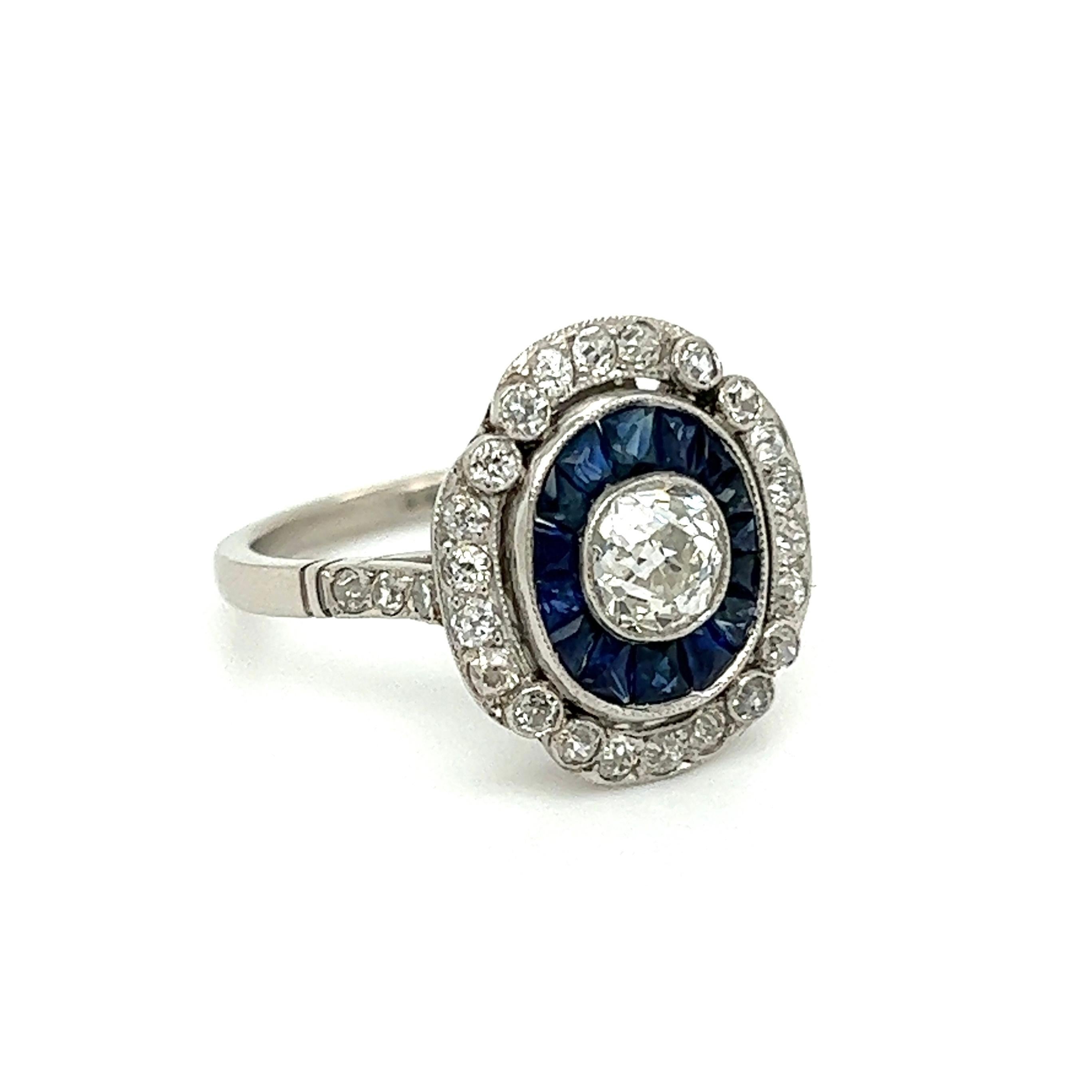 Simply Beautiful! Blue Sapphire and Diamond Cocktail Ring. Centering a securely nestled Hand set Old Mine-Cut Diamond, weighing 0.65 Carat. Surrounded by Sapphires weighing approx. 2.00tcw and Diamonds approx. 1.04tcw. Hand crafted Platinum