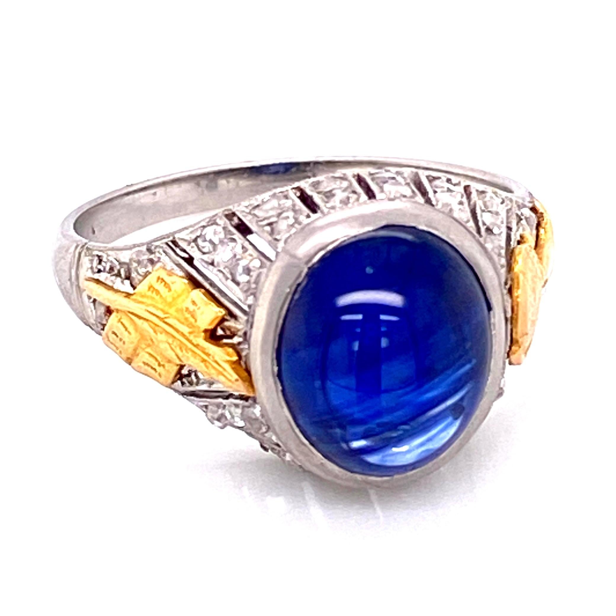 Simply Beautiful! Finely detailed Sapphire and Diamond Cocktail Ring, center securely Bezel set with a cabochon Blue Sapphire weighing approx. 4.50 Carat enhanced with rose cut side diamonds weighing about 0.30tcw. Accented in Yellow Gold, on one