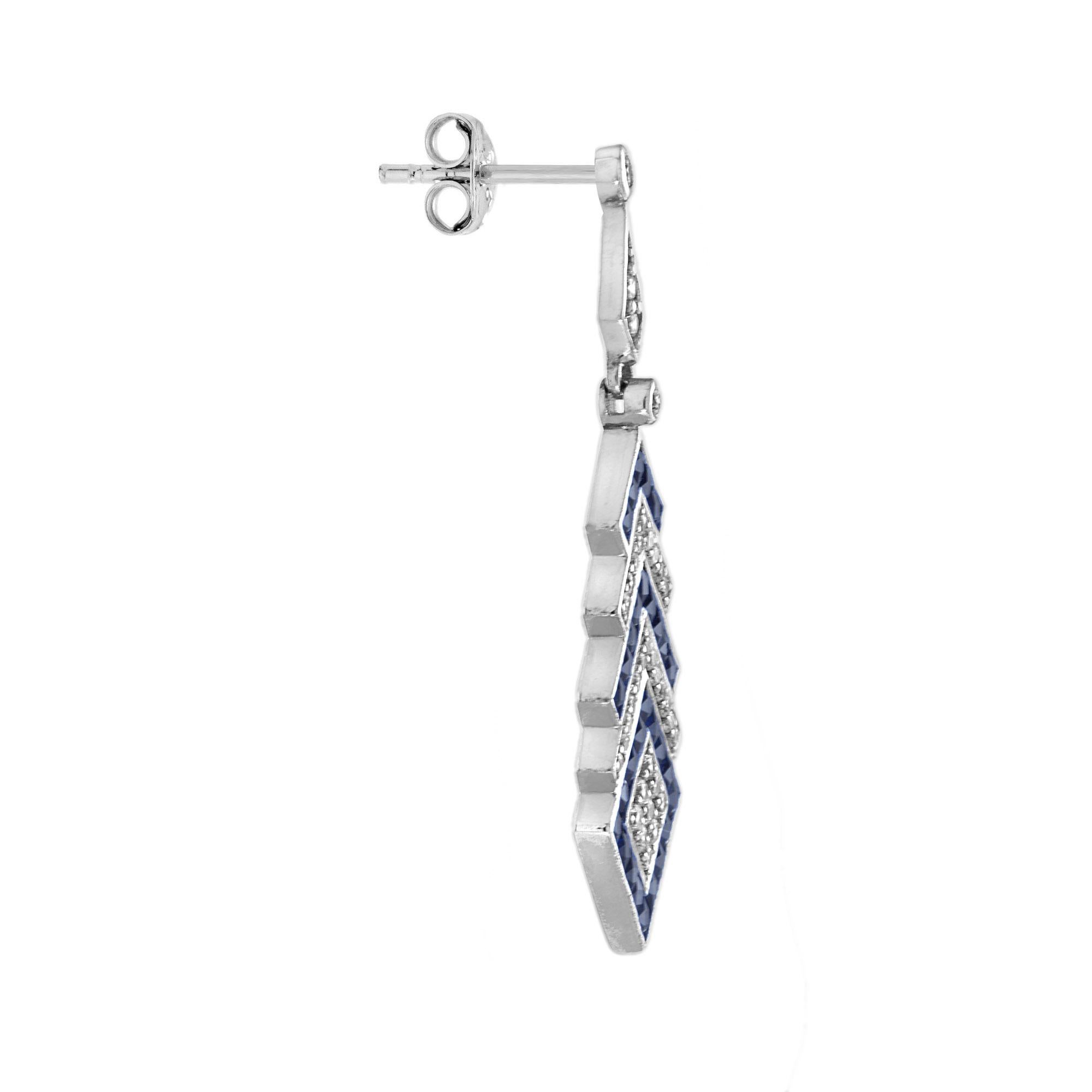 A striking layered design that begins with a square-shaped diamond at the center. Surrounding it is a bold sapphire border, followed by an elegant outer frame of alternating diamonds and sapphires. The geometric arrangement and vibrant contrast