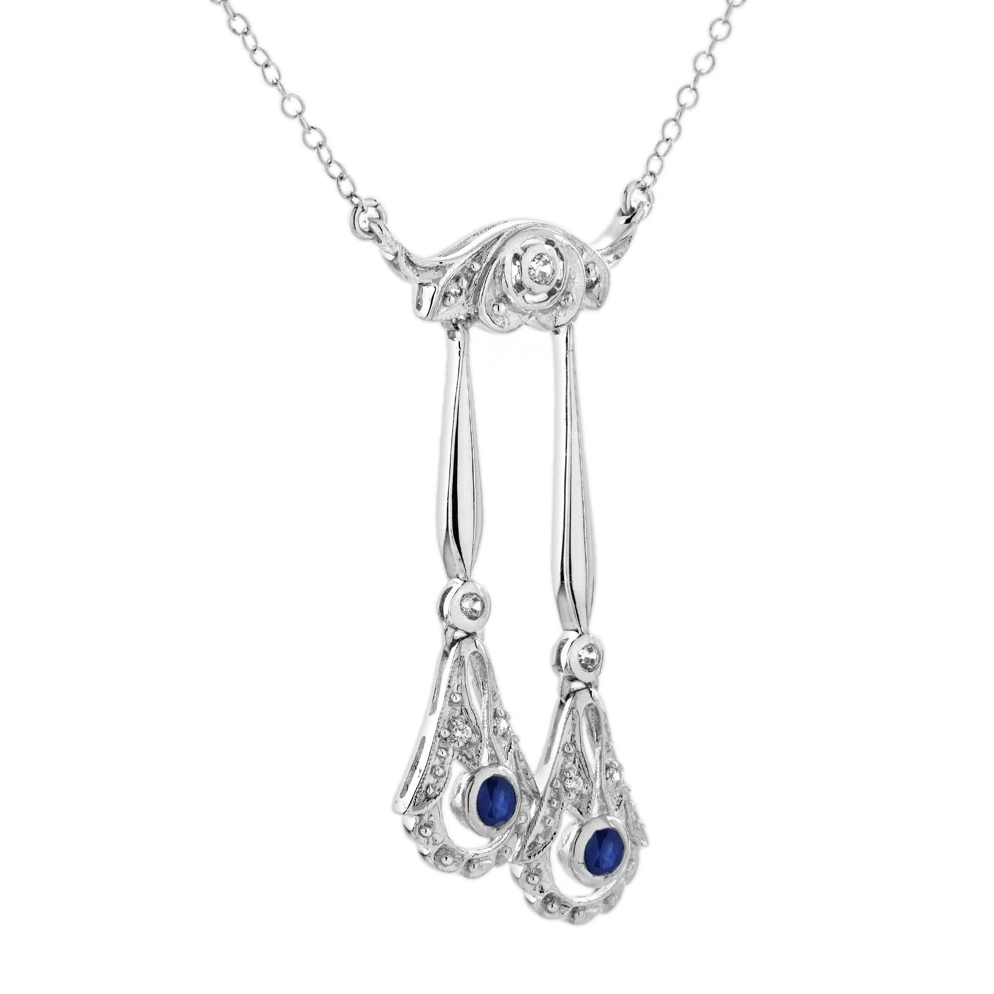 Un diamante scintillante al centro in alto, che conduce con grazia a una goccia ornata da due vibranti zaffiri blu. L'elegante combinazione di diamanti brillanti e ricchi zaffiri blu crea un contrasto sorprendente, catturando la simmetria e il