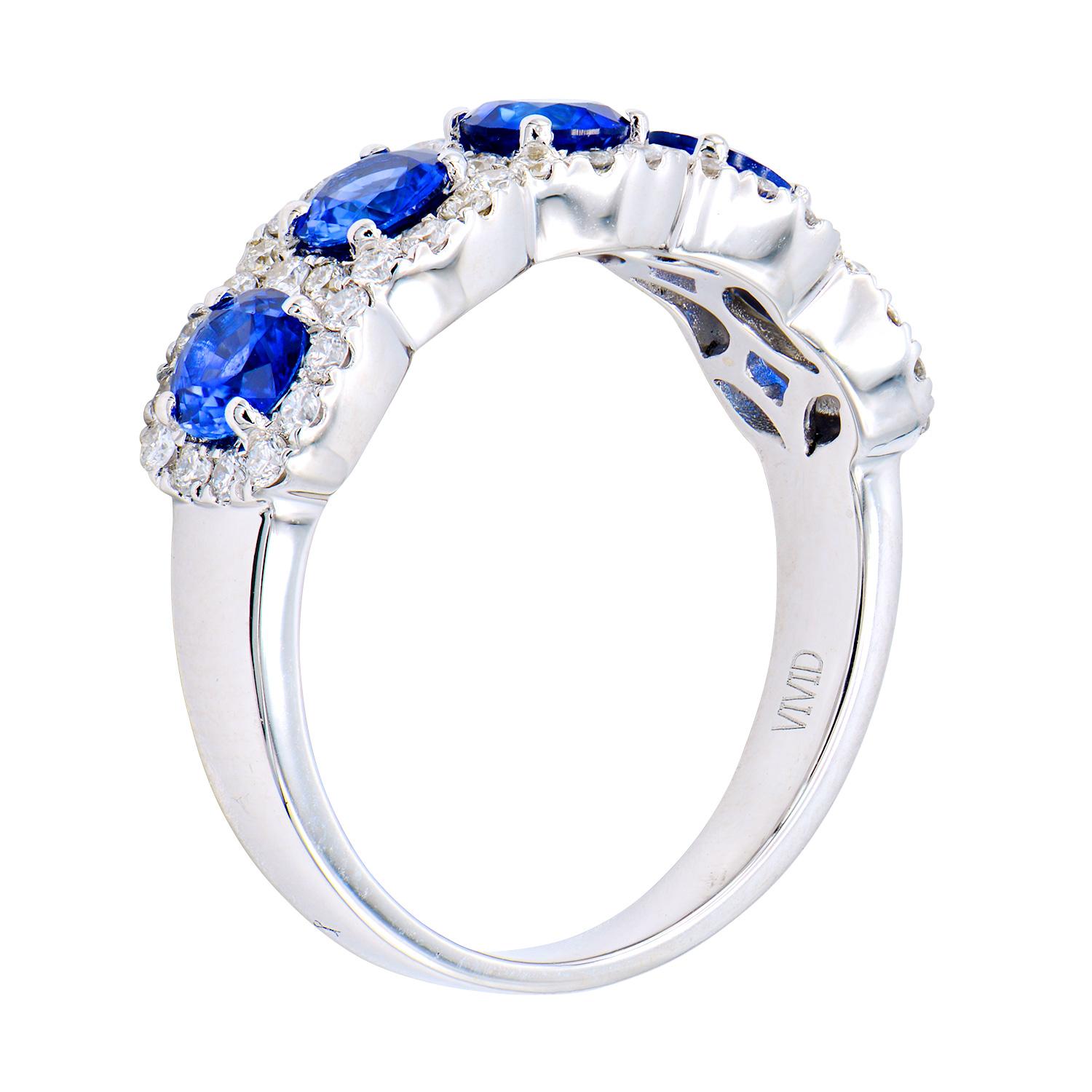 This sapphire and diamond band has 5 royal blue sapphires totaling 1.58 carats, Each sapphire is circled by VS2, G color diamonds totaling 0.43 carats which is made up by 52 round diamonds. These gorgeous stones are set in 4.0 grams of 18 karat