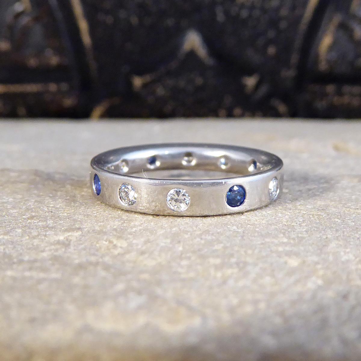 A beautifully set full Diamond and Sapphire band ring. Set into a 3.2mm Platinum band are four bright and blue Sapphires with two Diamonds of equal size set in between the Sapphires at an equal distance giving it the same pattern throughout the