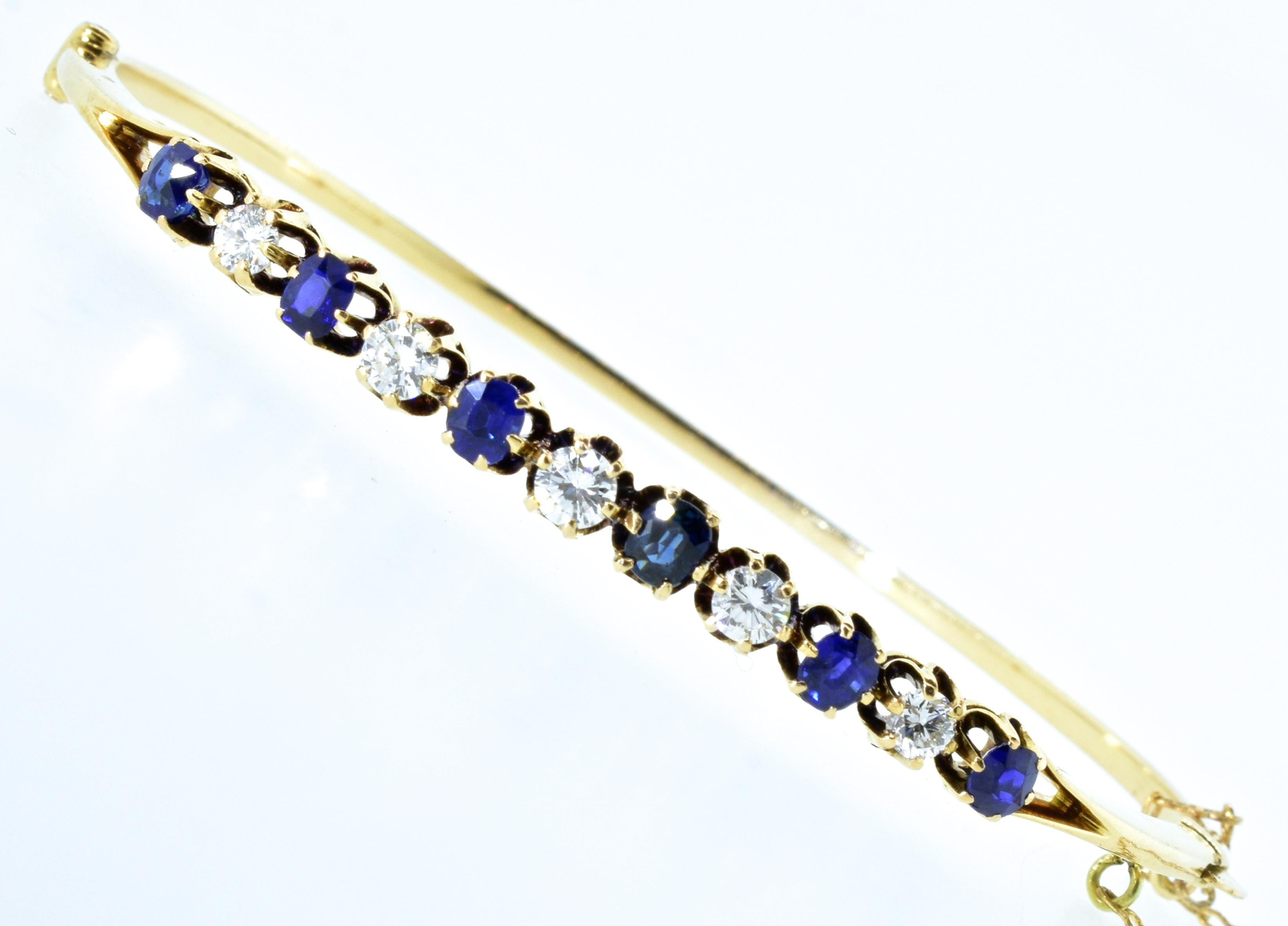 18K bangle bracelet prong set with fine vivid blue sapphires weighing approximately 1.2 cts., and interspersed with fine white diamonds weighing .50 cts.   The diamonds are all well cut and well matched, near colorless (H) and very slightly included