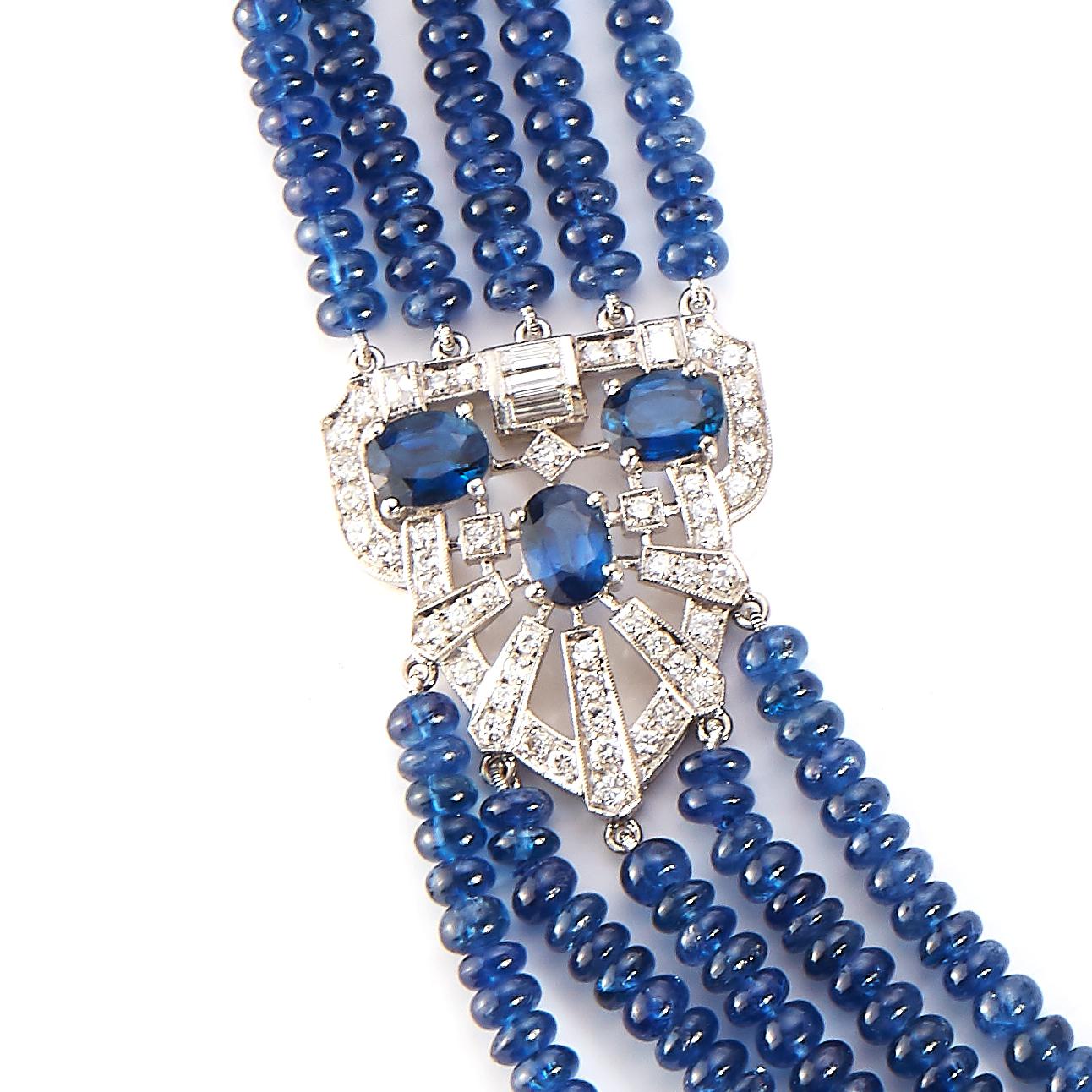Estate Jewelry Curated by Parulina- This Blue Sapphire and Diamond necklace consists of multiple strands of Sapphire Beads accented with larger Blue Sapphires and Diamonds to beautifully frame the sides of necklace. This necklace has 625ct of