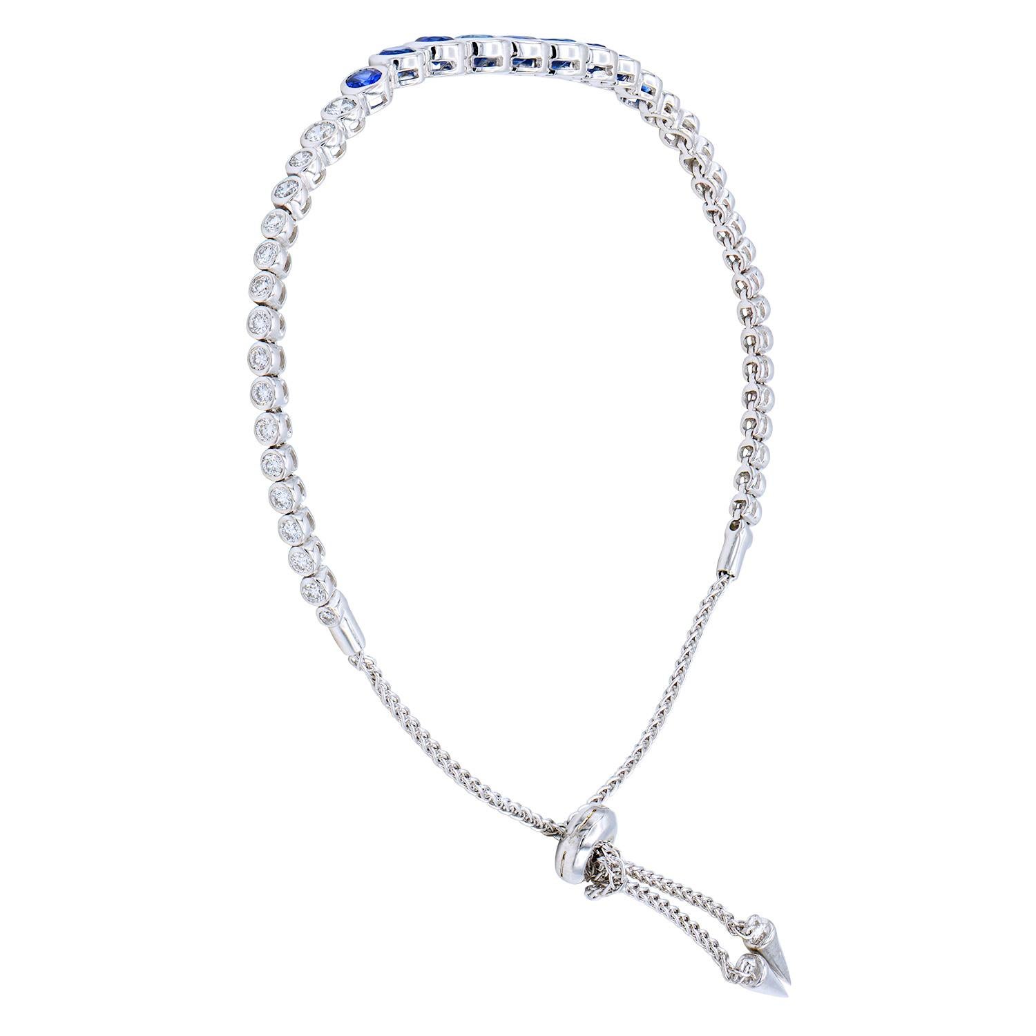 This fun and beautiful bracelet is gorgeous alone or stacked with others. This bracelet has 9 Sapphires graduated towards the center totaling 1.83 carats, with VS2, G color diamonds on both sides of the sapphires. There are 34 round diamonds