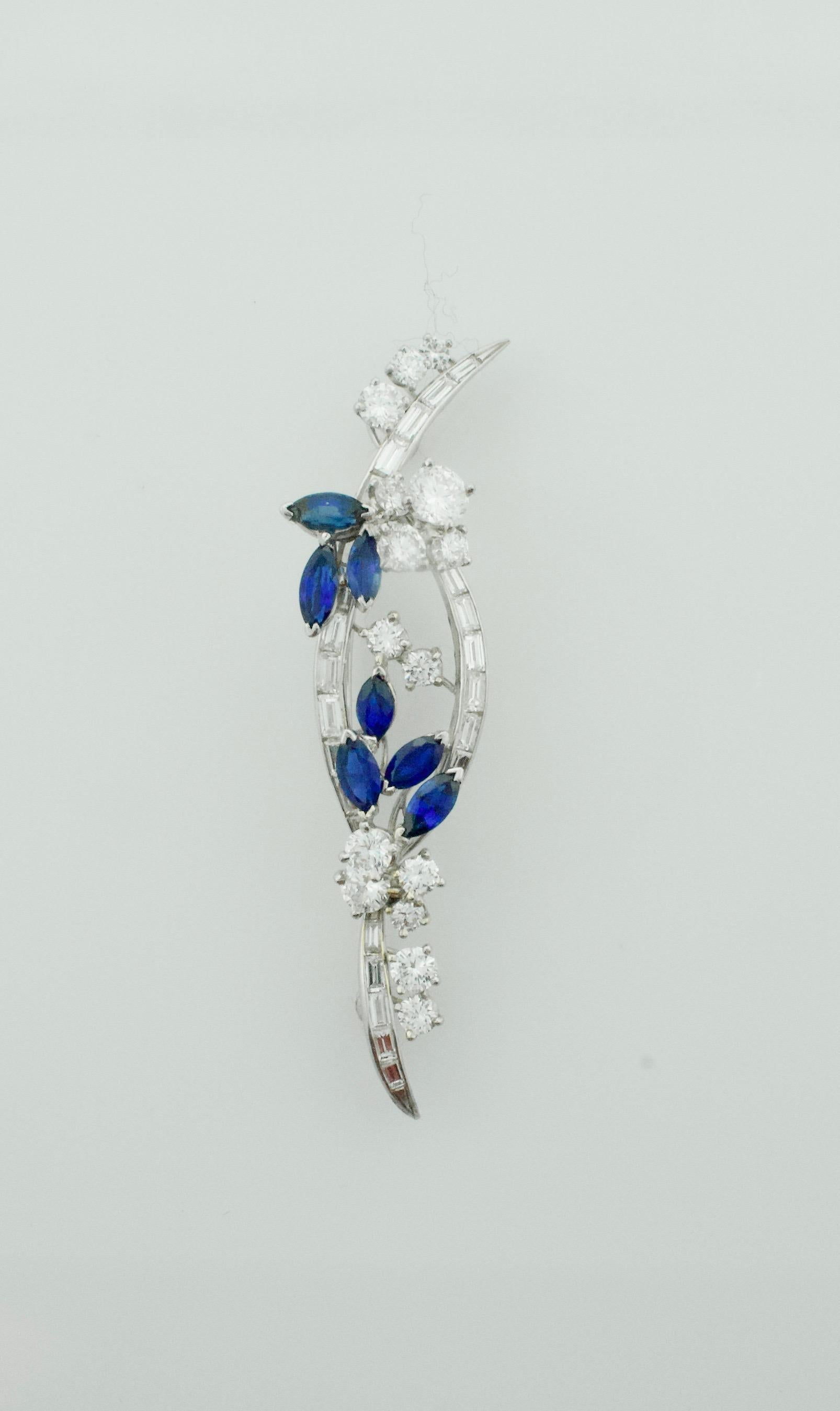Sapphire and Diamond Brooch by Oscar Heyman and Brothers
Total Diamond Weight 4.20 Carats Approximately  [all F-G-H VVS]
One  Round Brilliant Cut Diamonds Weighing .35 Carats Approximately
Four Round Brilliant Cut Diamonds Weighing 1.00 Carats