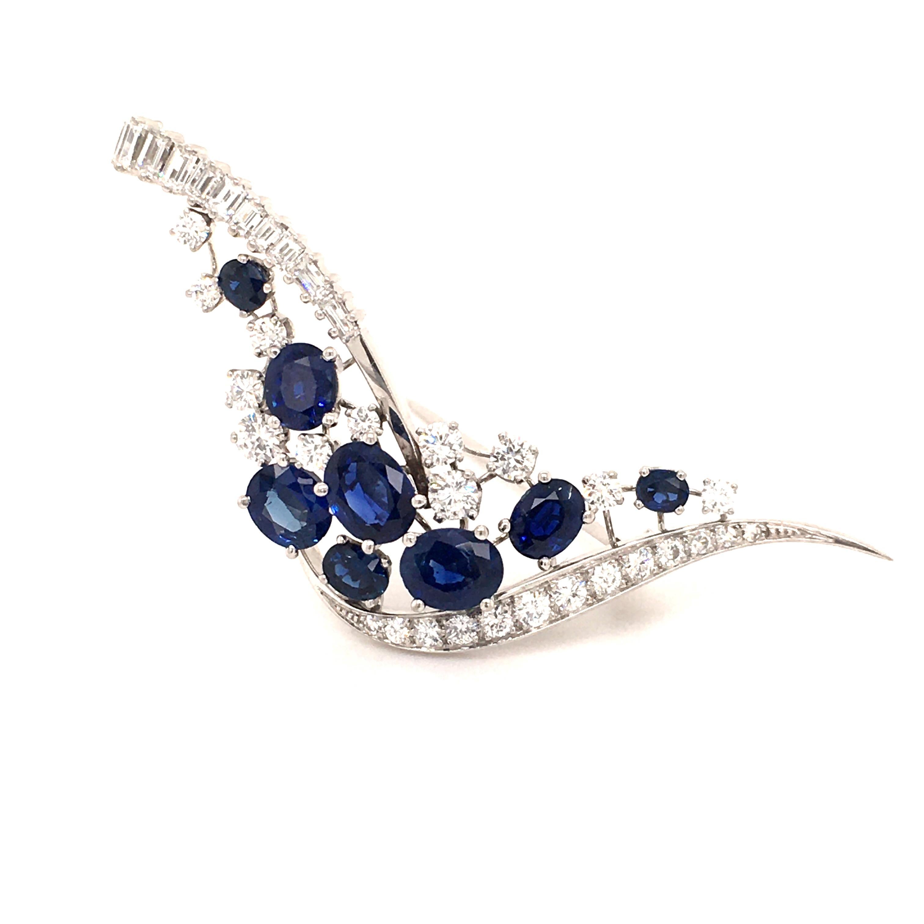 This stylized bird or wave brooch is set with 8 intensely colored oval shaped sapphires, total weight approximately 3.60 carats. Origine of the sapphires is Cambodia. Accented by 35 round and baguette shaped diamonds of G/H color and vs clarity,