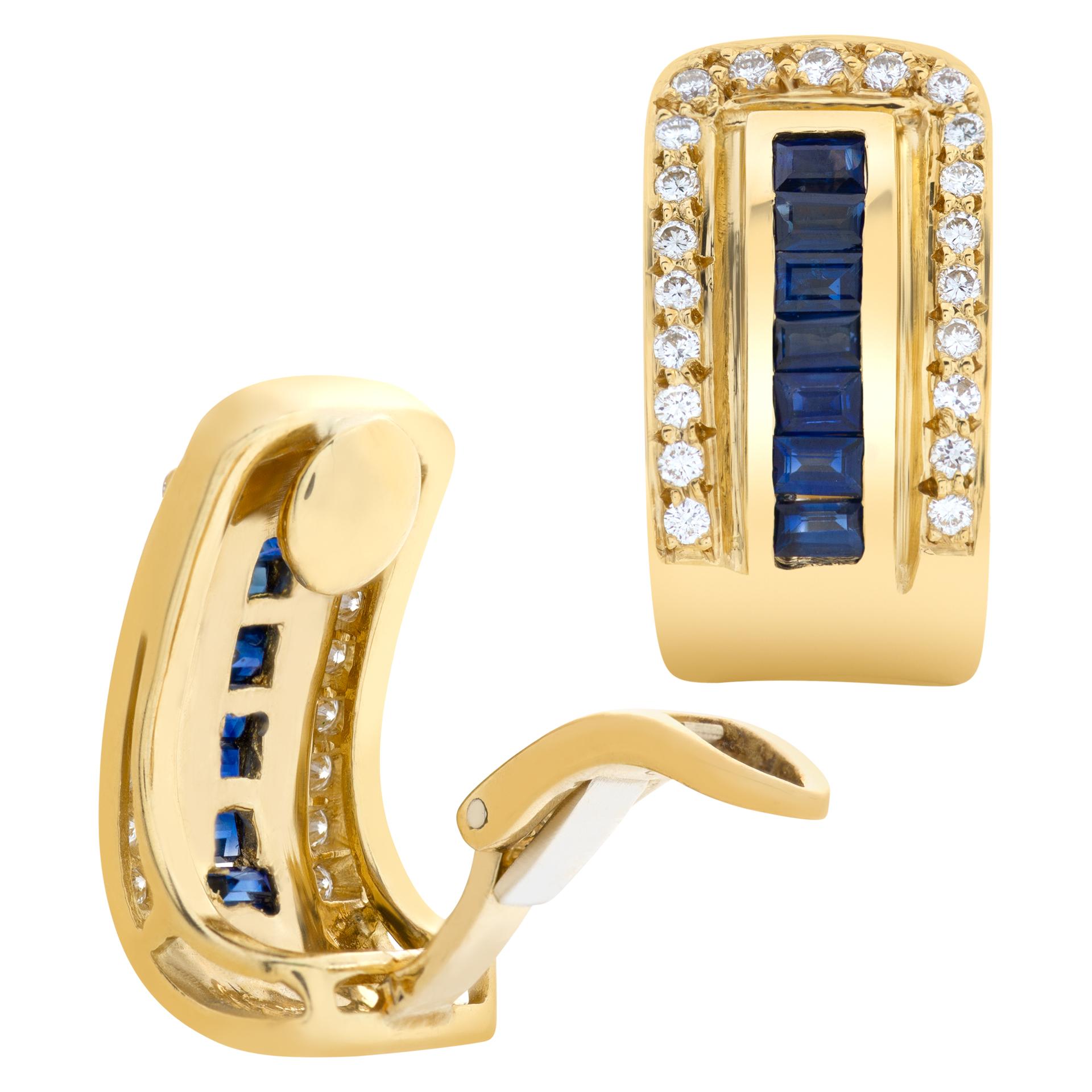 ESTIMATED RETAIL $4,700.00 - YOUR PRICE $3,490.00 - Elegant pair of 18K yellow gold semi hoop style earrings. Tapered baguette sapphires (totaling approximately 1 carat) & full cut round brilliant diamond (totaling approximately 0.75 carats).