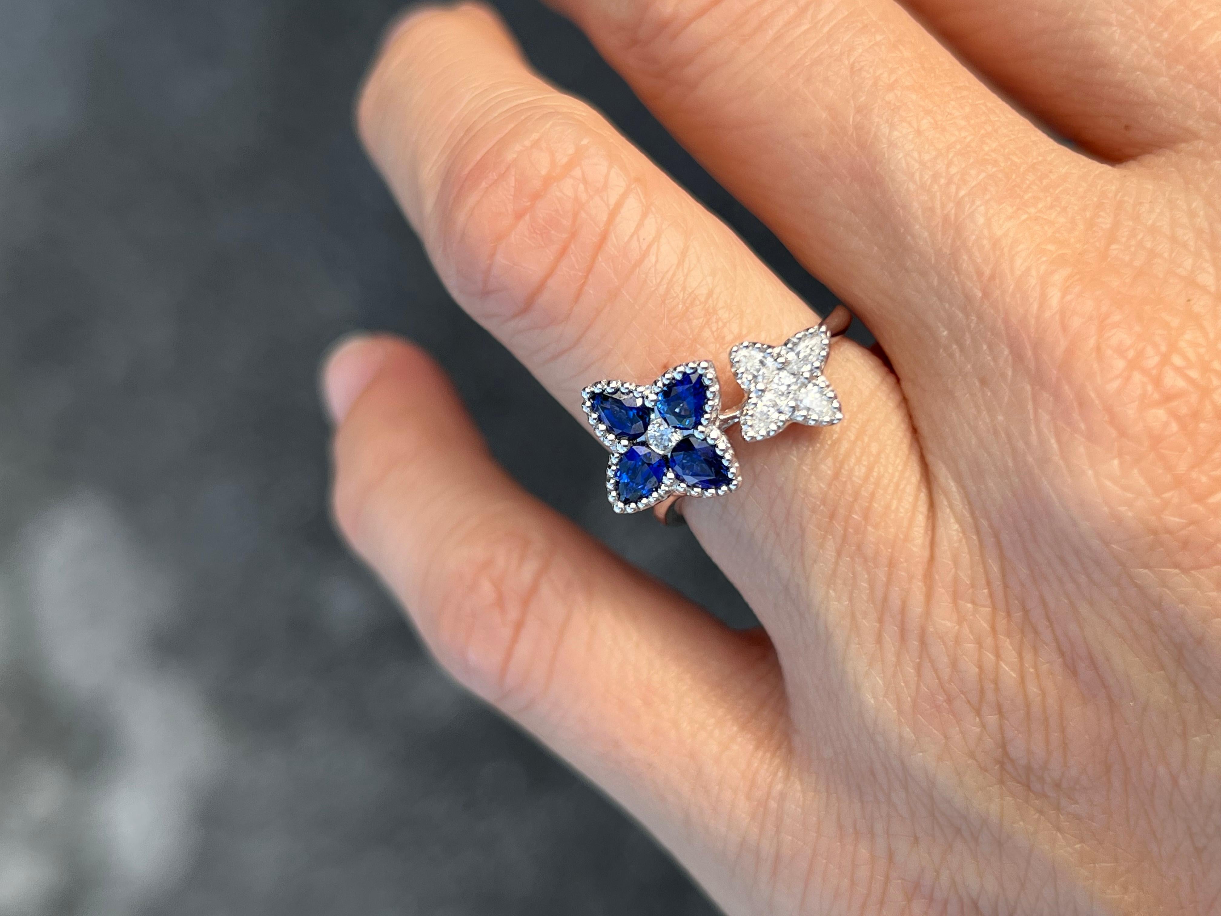 18K white gold ring with pear shaped sapphires that make a clover shape with a round diamond in the center. Also, a second clover made of pear shaped diamonds with a small round diamond in the center. 

Features
18K white gold
1.07 carat total