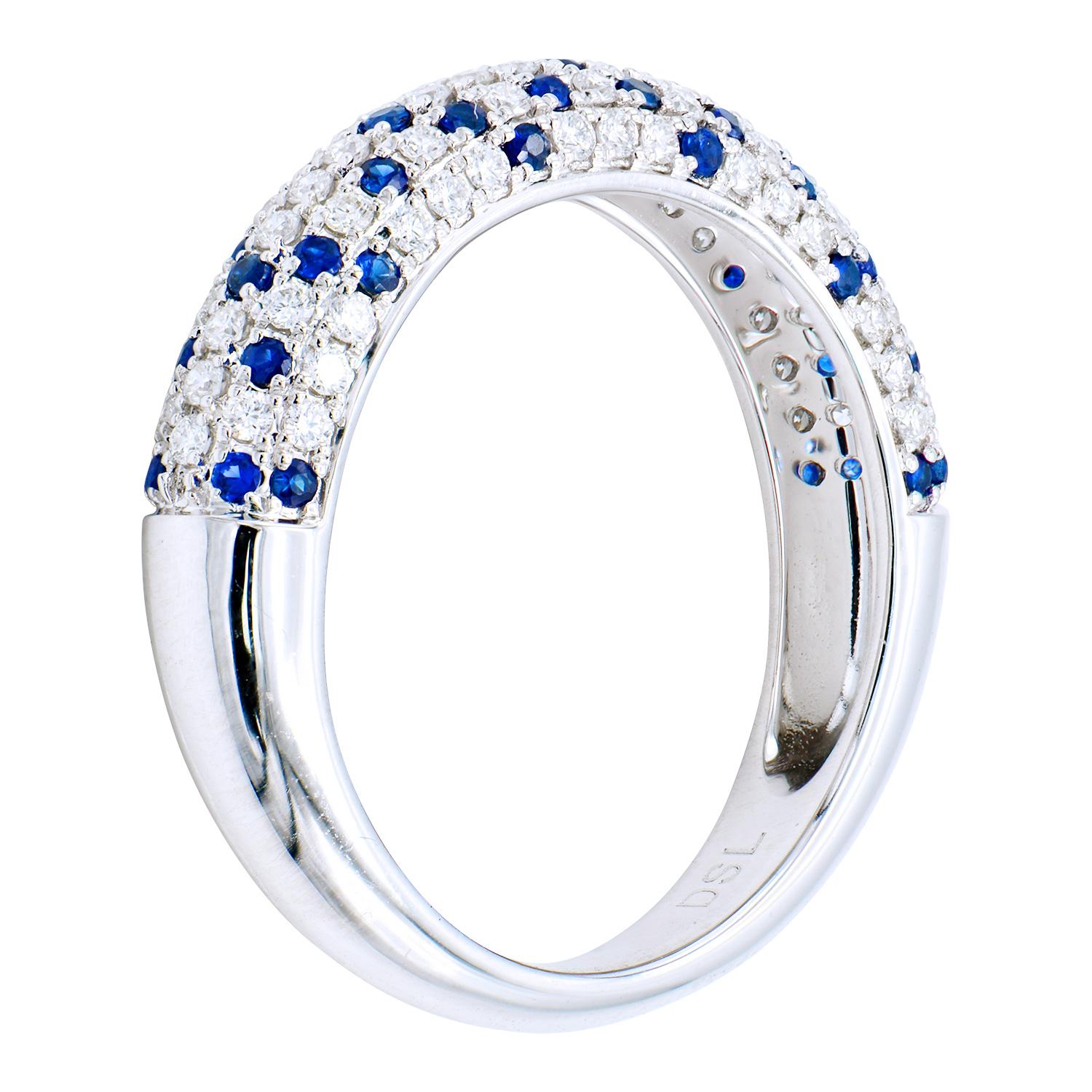 This unique ring has 5 rows of diamonds and sapphires that go halfway around the ring. Between all the rows there are 41 sapphires and 70 round diamonds, each row having its own pattern. The sapphires total 0.26 carats and the diamonds are VS2, G