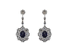 Sapphire and diamond cluster earrings, circa 1920.