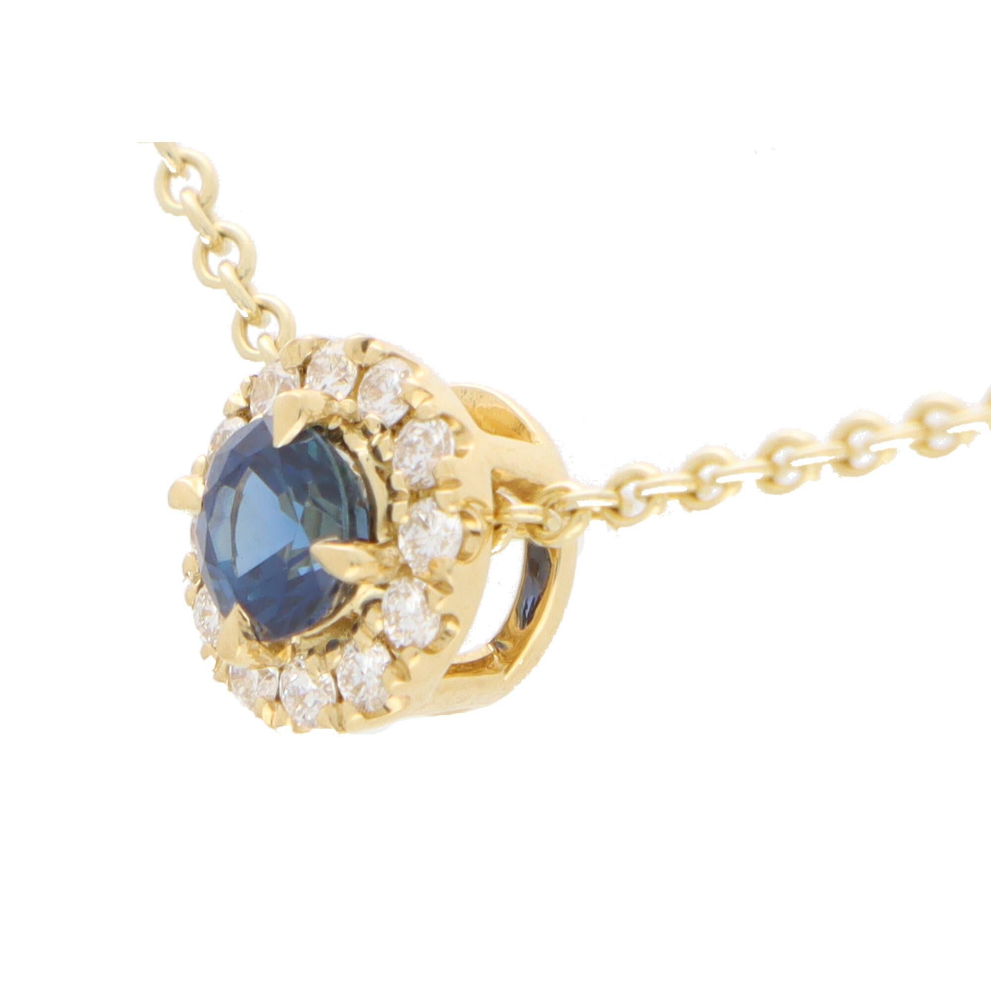 A beautiful sapphire and diamond cluster pendant set in 18k yellow gold.

The pendant is centrally set with a vibrant blue coloured round cut sapphire which is surrounded by 12 sparkly round brilliant cut diamonds. The pendant hangs from a 9k yellow