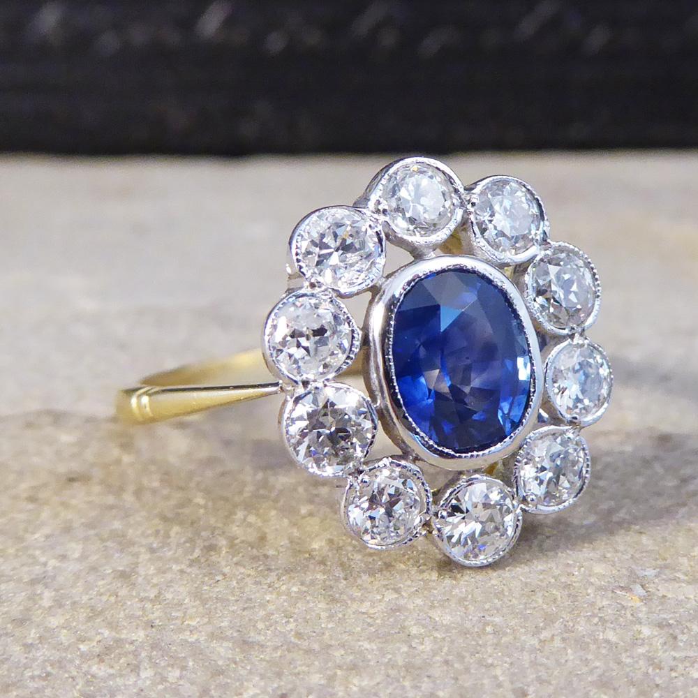 This lovely contemporary Sapphire and Diamond ring has been crafted with a 1.25ct gorgeous blue Sapphire centre, surrounded by ten modern brilliant cut Diamonds. Using larger Diamonds in this cluster ring allows there to be spacing between the