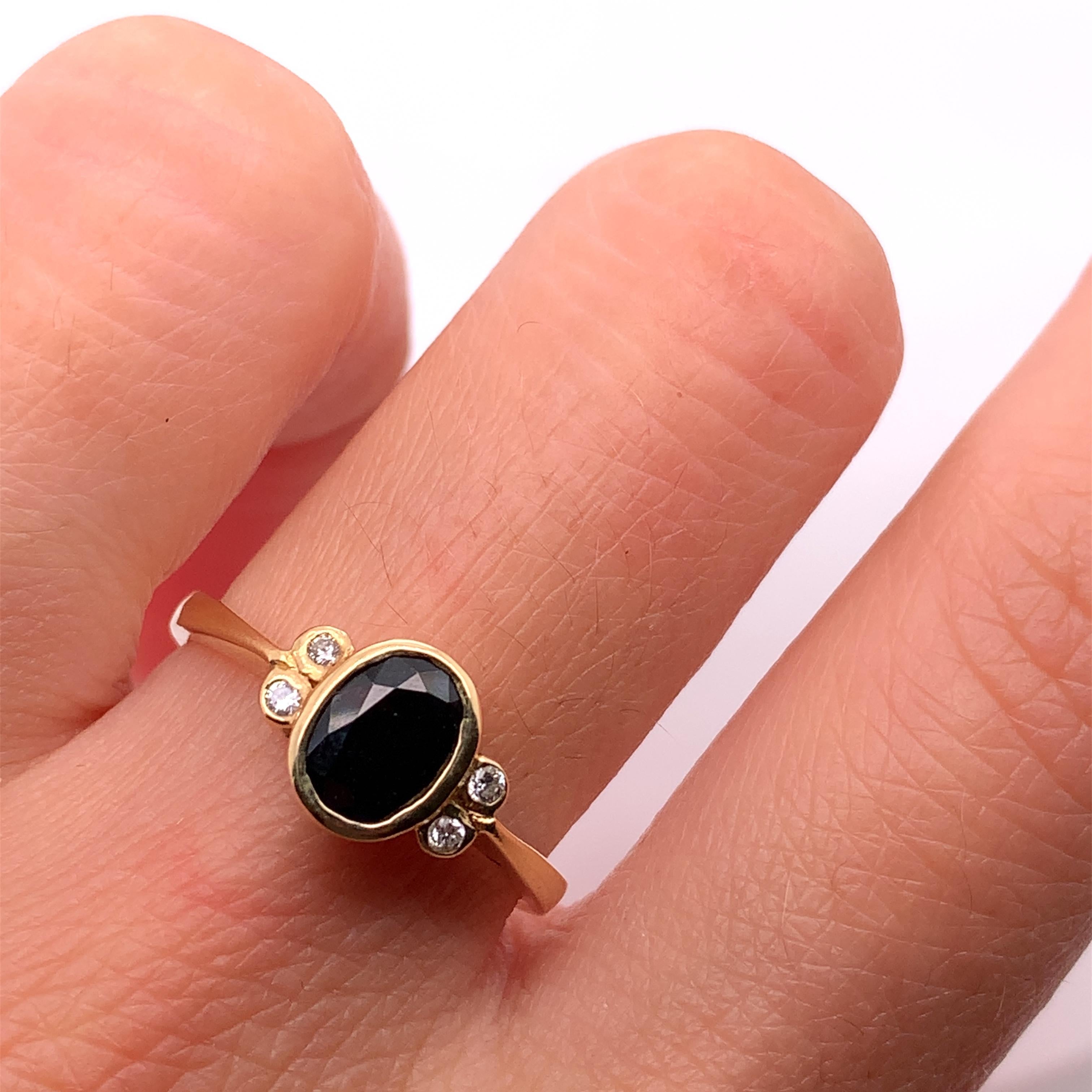 This beautiful ring features a stunning 0.80ct sapphire diamond in a solitaire setting, crafted with 18ct yellow gold. The ring is further adorned with two additional sapphire and diamond gemstones, making it the perfect eternity or engagement ring