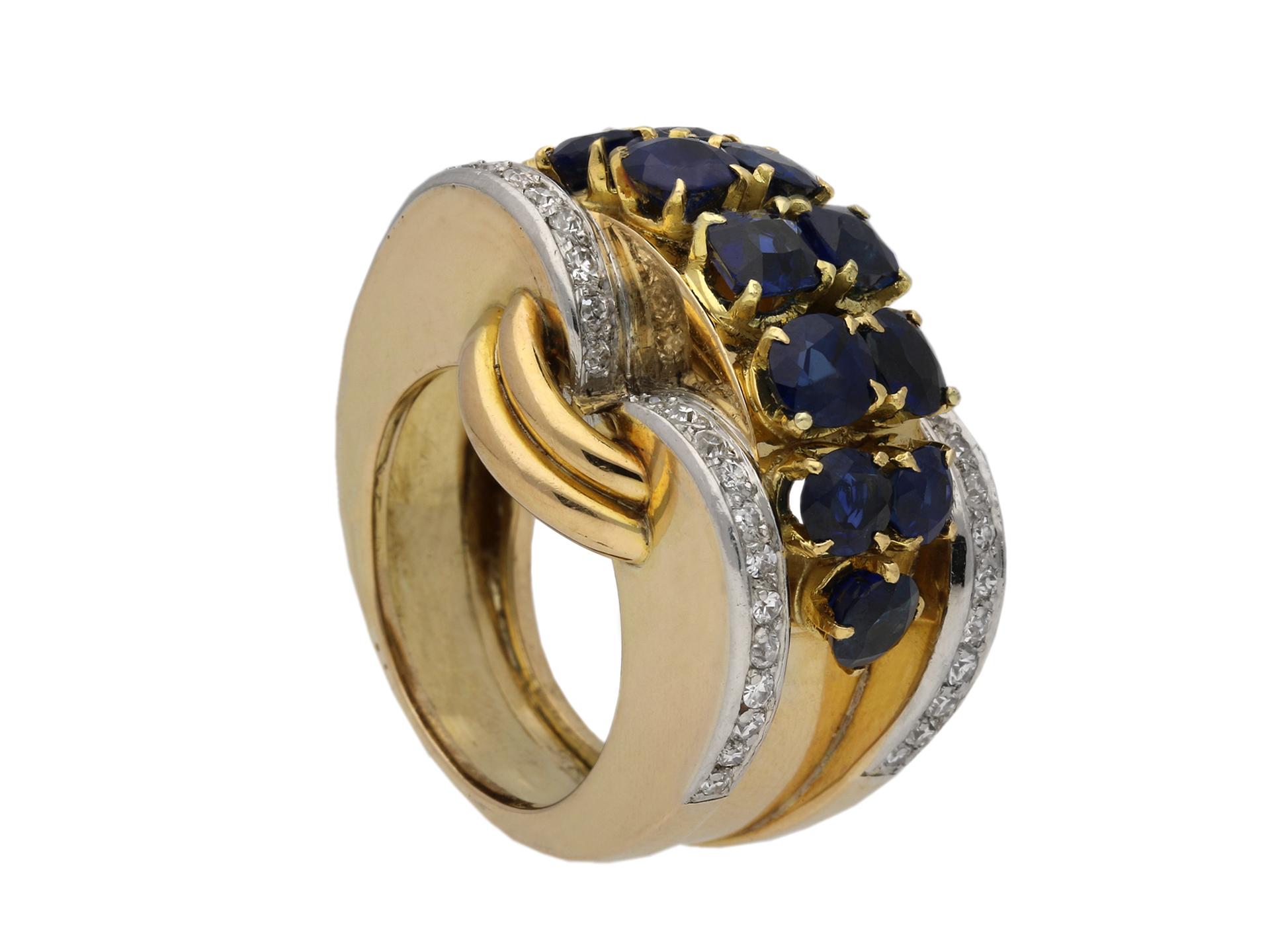 Sapphire and diamond cocktail ring, French, circa 1945. A rose gold and platinum ring with heavy protruding bezel set with a horizontal double row of twelve round old cut sapphires in yellow gold claw settings with an approximate total weight of