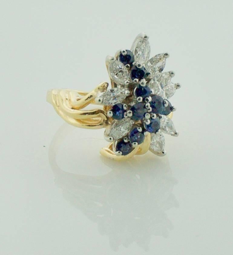Sapphire and Diamond Cocktail Ring in Yellow Gold
Nine Marquise Diamonds weighing 1.35 carat approximately
Nine Round Sapphires weighing .60 carat approximately 
Diamond are GH in color and VVS- SI1 in Clarity
Sapphires are Bight Blue
Flash This