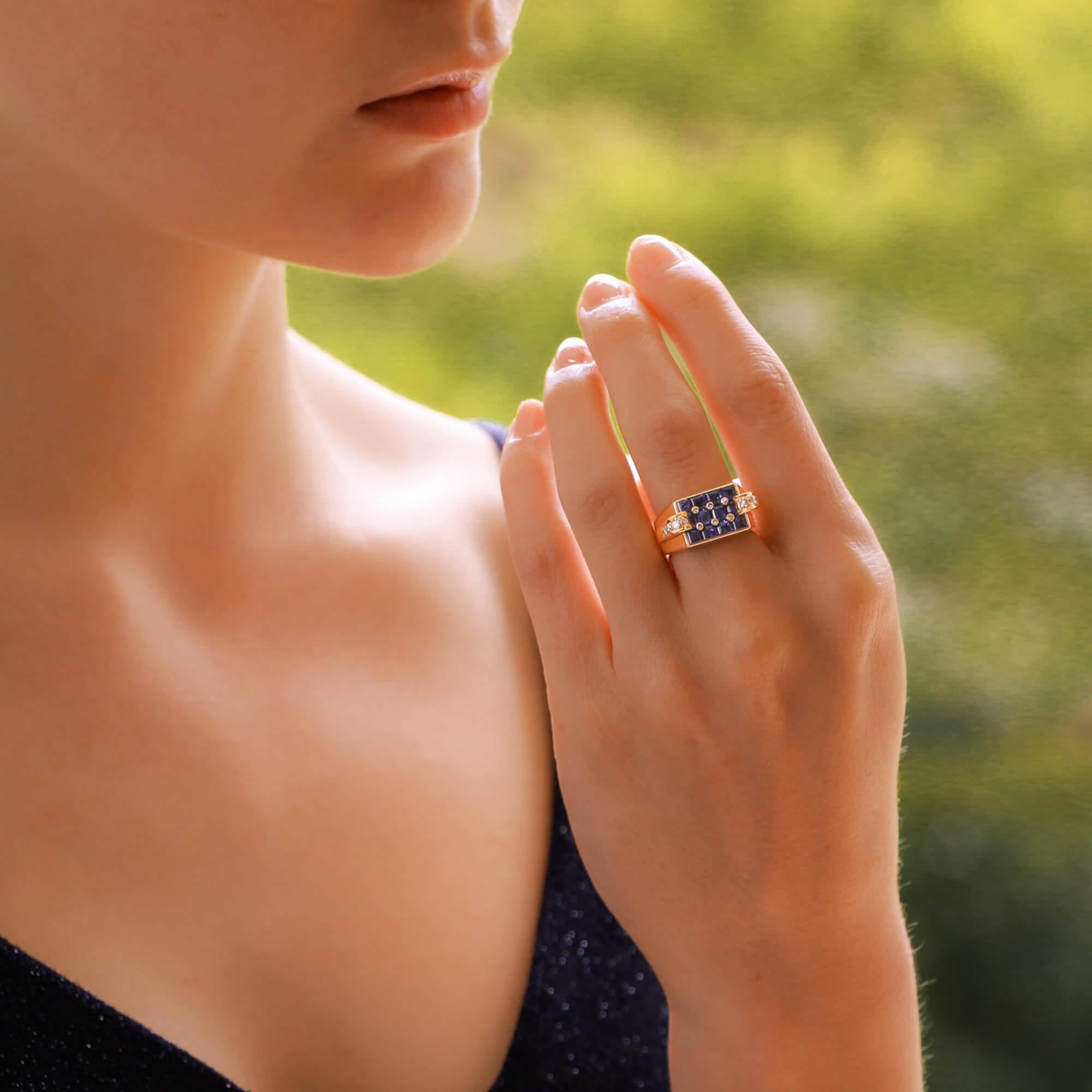 A highly unique Art Deco inspired sapphire and diamond cocktail ring set in 18 karat rose gold.

This ring is estimated to be made in the 1940's and is designed with a central plaque of 12 invisibly-set calibre-cut sapphires. These sapphires have a