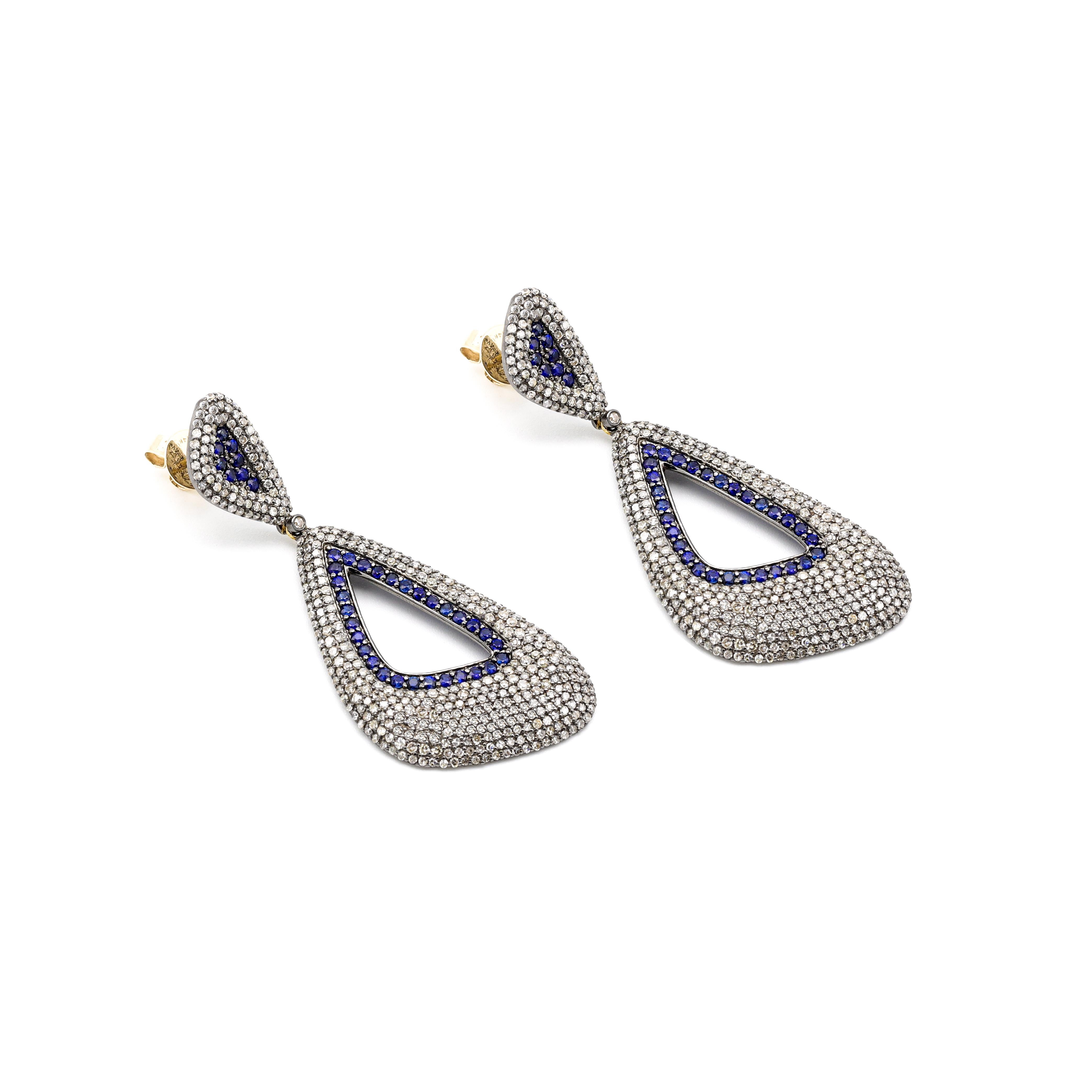 Sapphire and Diamond Cocktail Statement Dangle Earrings in Victorian Style

This victorian style majestic curvaceous space blue sapphire and diamond earring is hypnotizing. The scalene triangle-shaped long earring pair is hollow in the center and