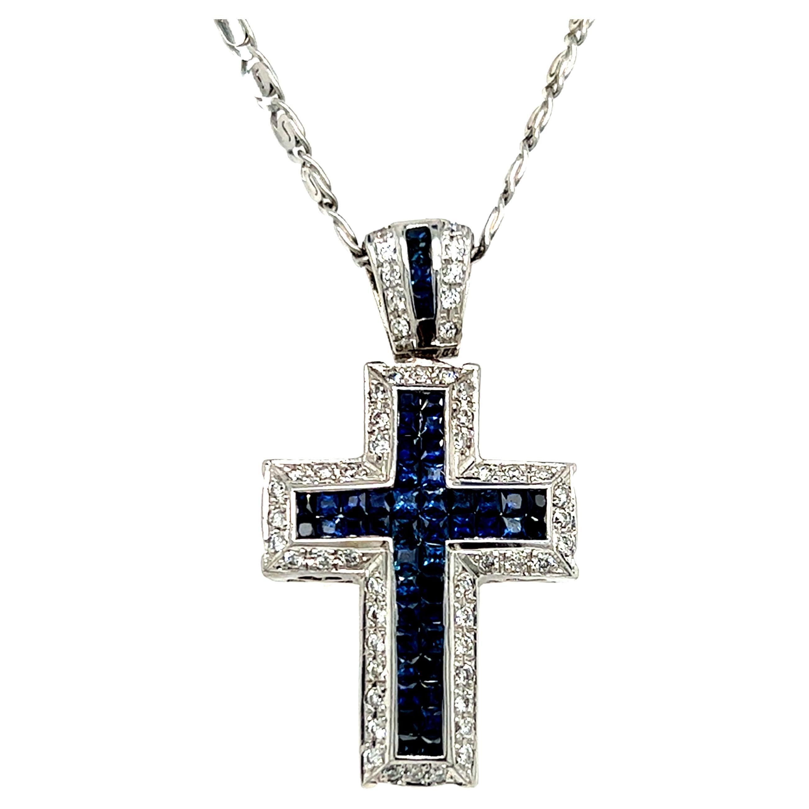 One 14 karat white gold cross pendant set with forty-four (44) princess cut sapphires, approximately 2.35 carat total weight, and forty-four (44) round brilliant cut diamonds, approximately 1.00 carat total weight with matching H/I color and SI