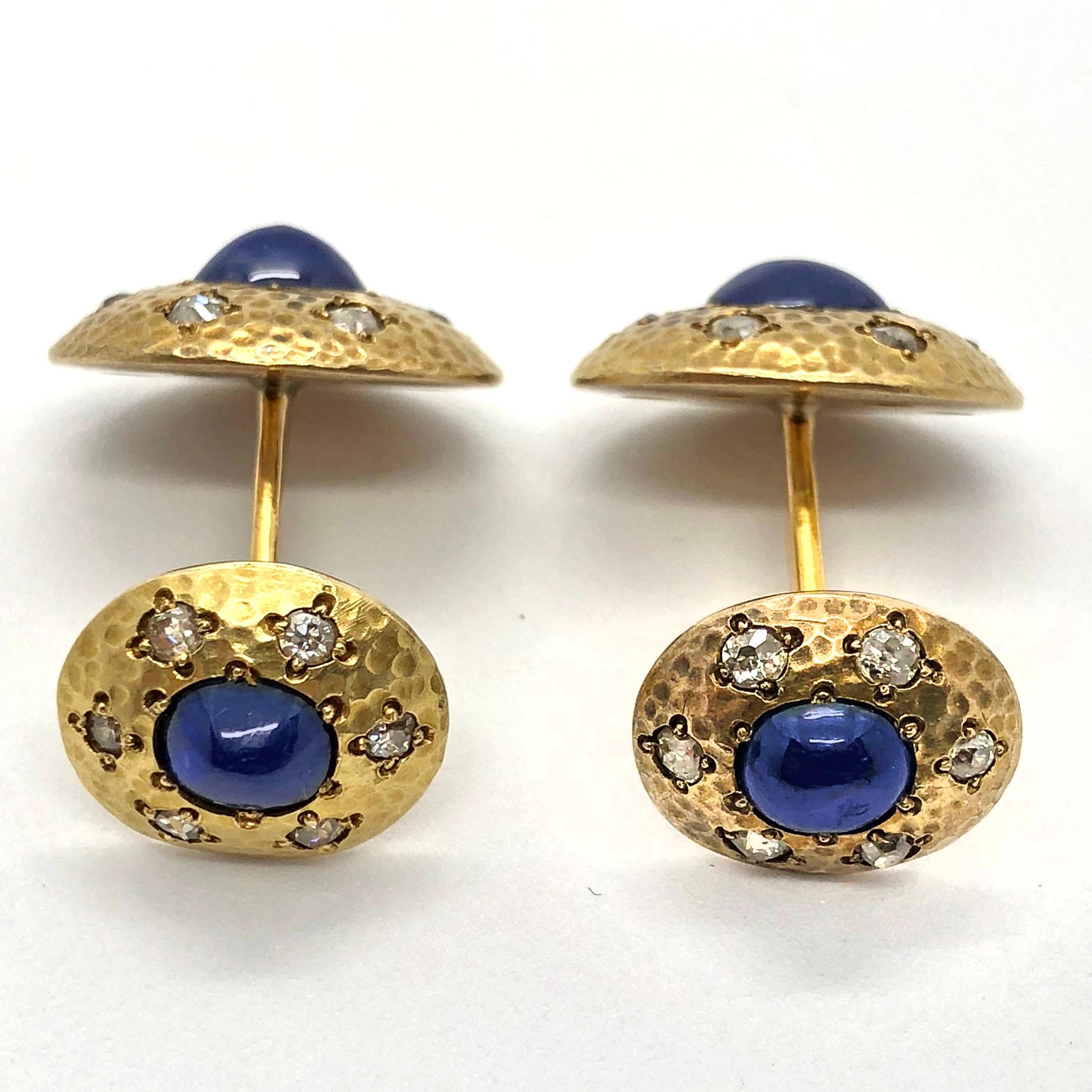 These beautiful cufflinks feature a deep royal blue sapphire cabochon in the centre, which is surround by six old cut diamonds. The smaller part of the cufflink can be turned for a more comfortable wearing.