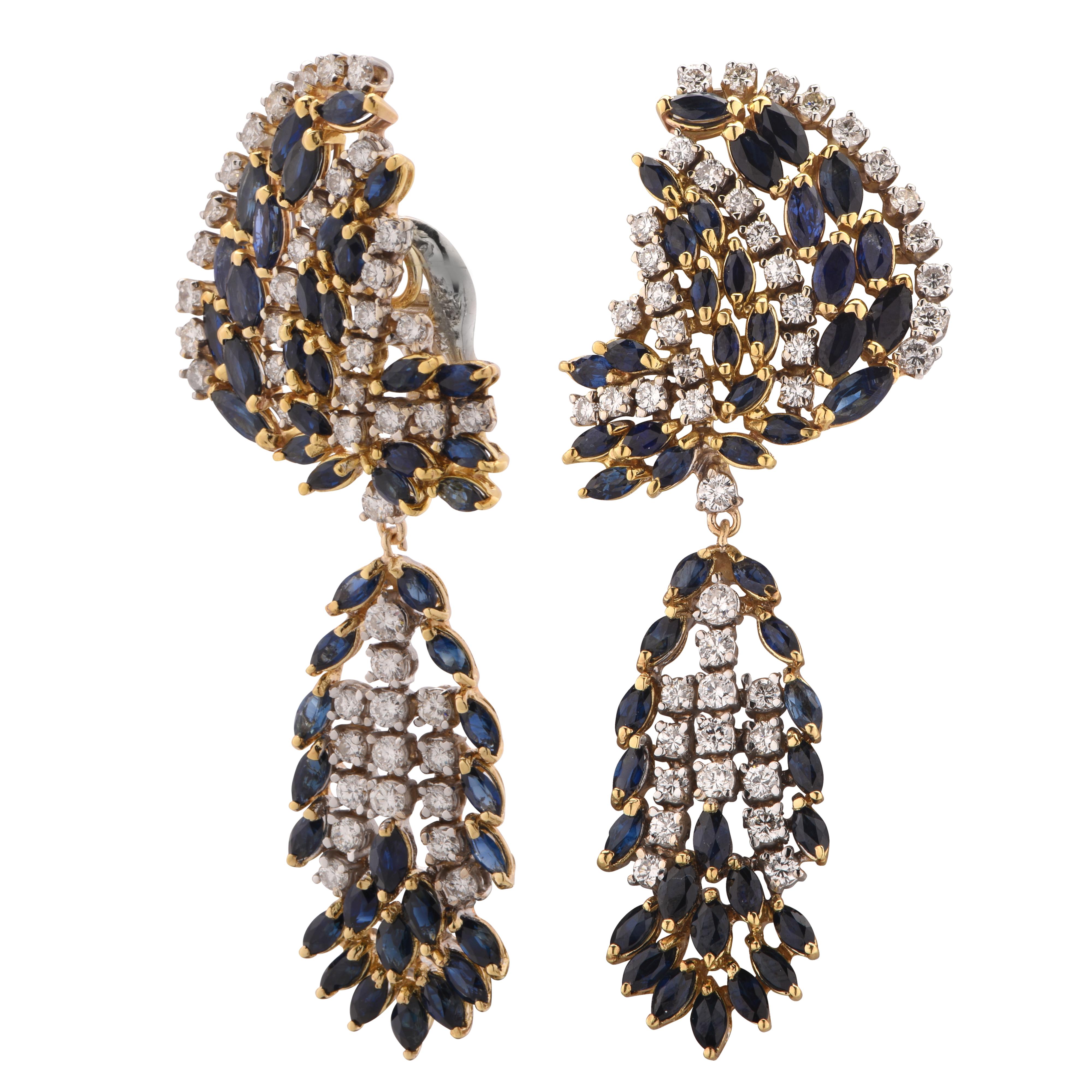 Dazzling dangle earrings crafted in 18 karat white and yellow gold featuring 90 round brilliant cut diamonds weighing approximately 4.5 carats total G color VS-SI clarity, accented by 102 marquise cut sapphires weighing approximately 10 carats