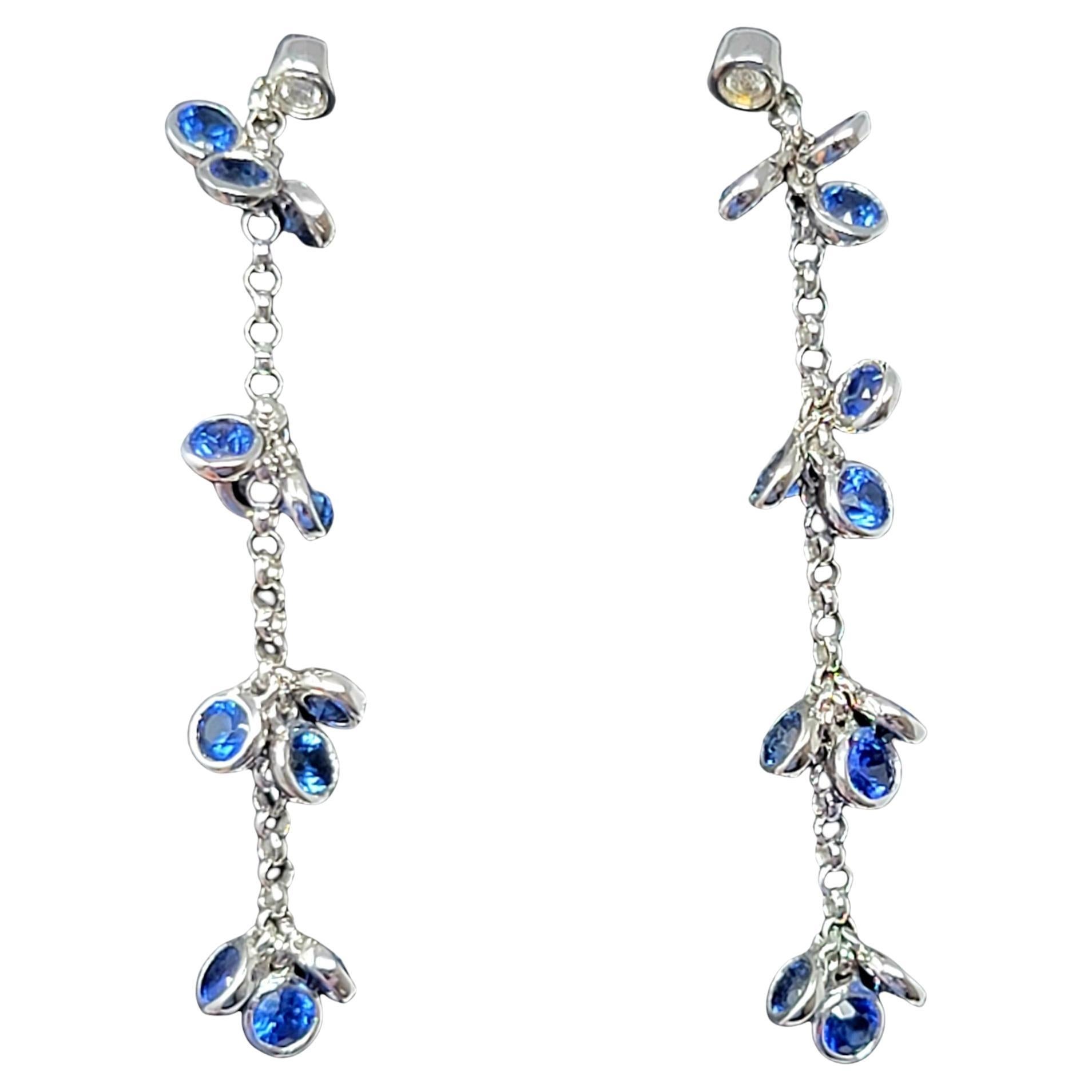 Stunning delicate diamond, sapphire and white gold dangle earrings glisten on the ear with gentle movement and sparkle beautifully in the light. 

Earring type: Dangle
Metal: 14K White Gold
Weight: 2.75 grams
Natural Sapphires: 1.44 ctw
Sapphire