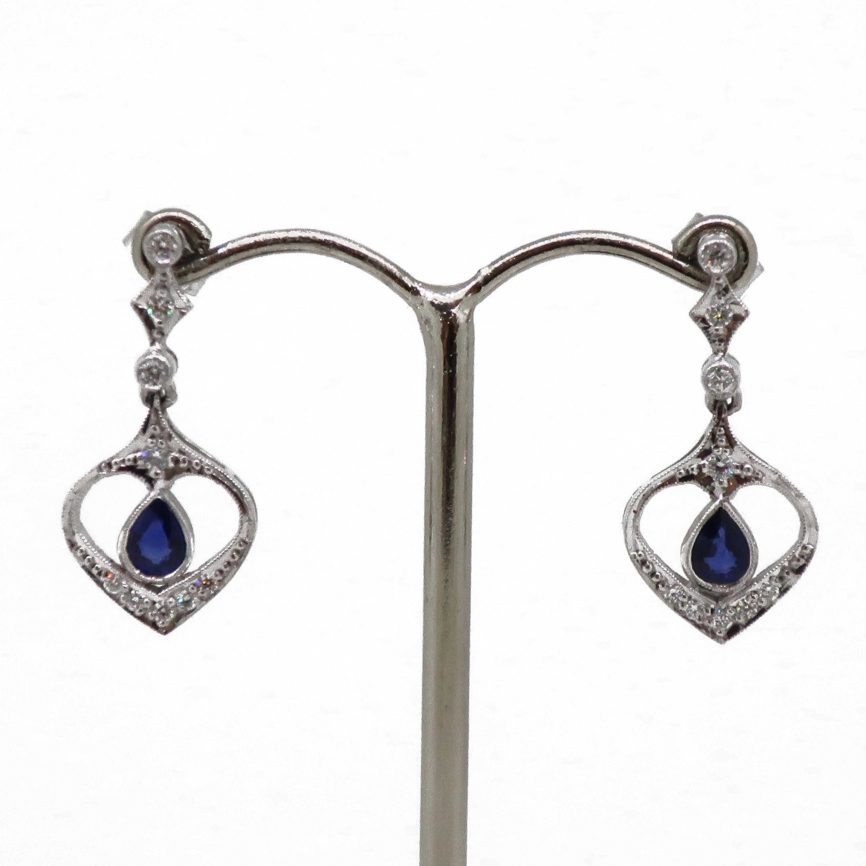 Sapphire And Diamond Drop Earrings 18 Karat White Gold 

Gorgeous sapphire and diamond drop earrings in a Art Deco design. The earrings consist of a pear shape sapphire in a open framework with brilliant cut diamonds surrounding them, with a diamond