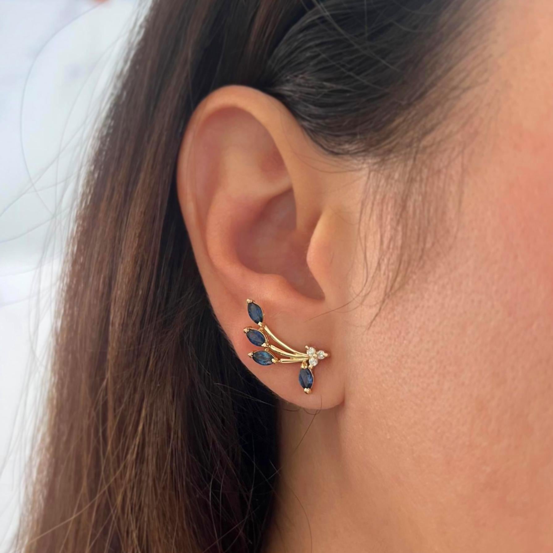 14 karat yellow gold ear crawlers featuring 8 marquise cut sapphires totaling 0.80 carats accented by 6 round diamonds of SI clarity and H/I color totaling 0.06 carats. Pierced post with friction back. Finished weight is 2.8 grams.