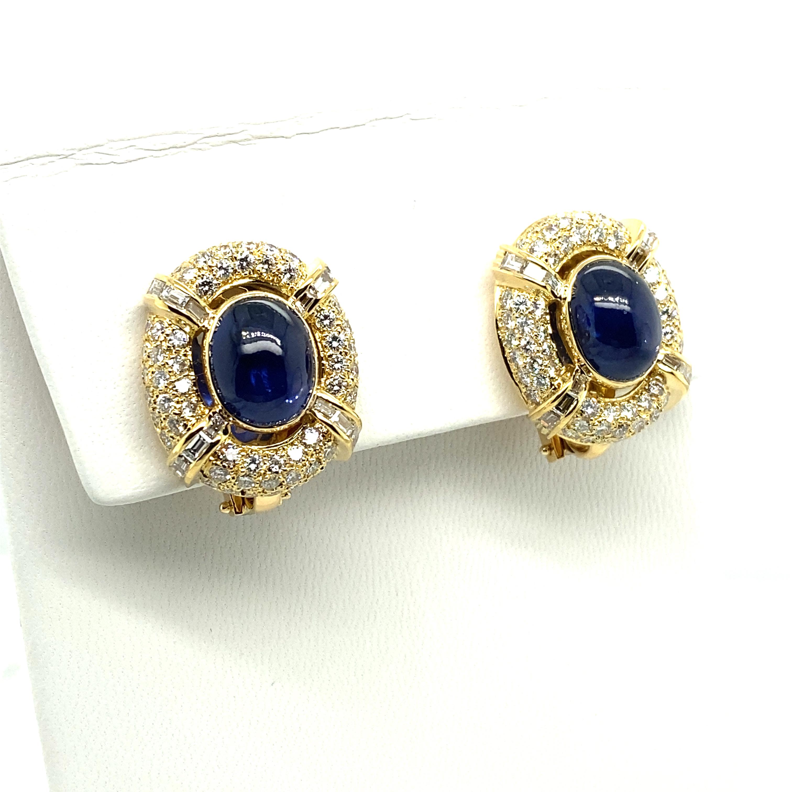 These opulently sparkling yet timelessly classic earclips from MAYOR's are crafted from 18 karat yellow gold and are bezel-set with two intense blue oval sapphire cabochons with a total weight of approximately 11.40 carats.
The entourages are pavé