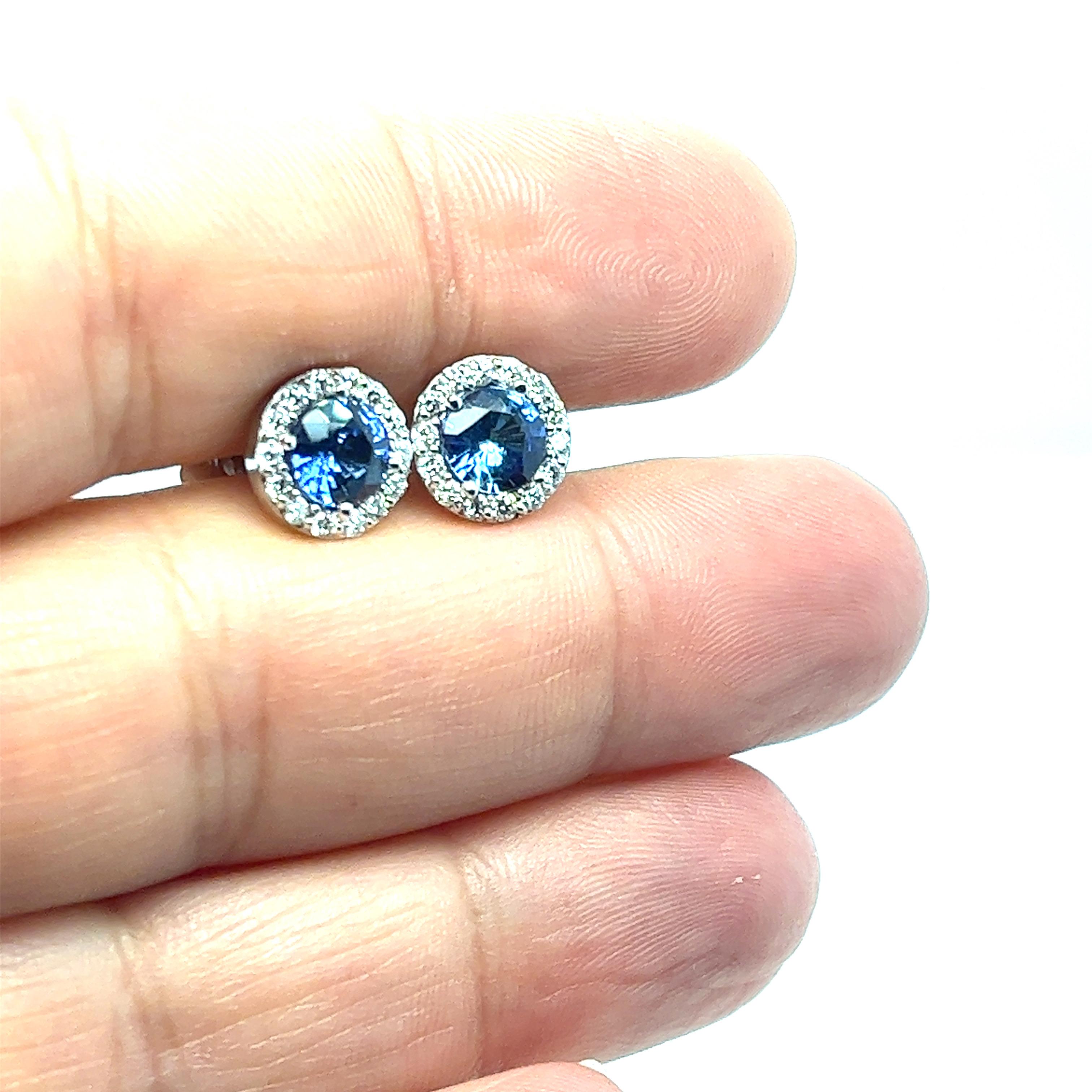 Offered here is a pair of earrings in 18 karat white gold with sapphires and round brilliant diamonds. Round sapphires, carat total weight 2.35 ct; diamonds, carat total weight .50.
Beautiful pair of matching round sapphires within a diamond