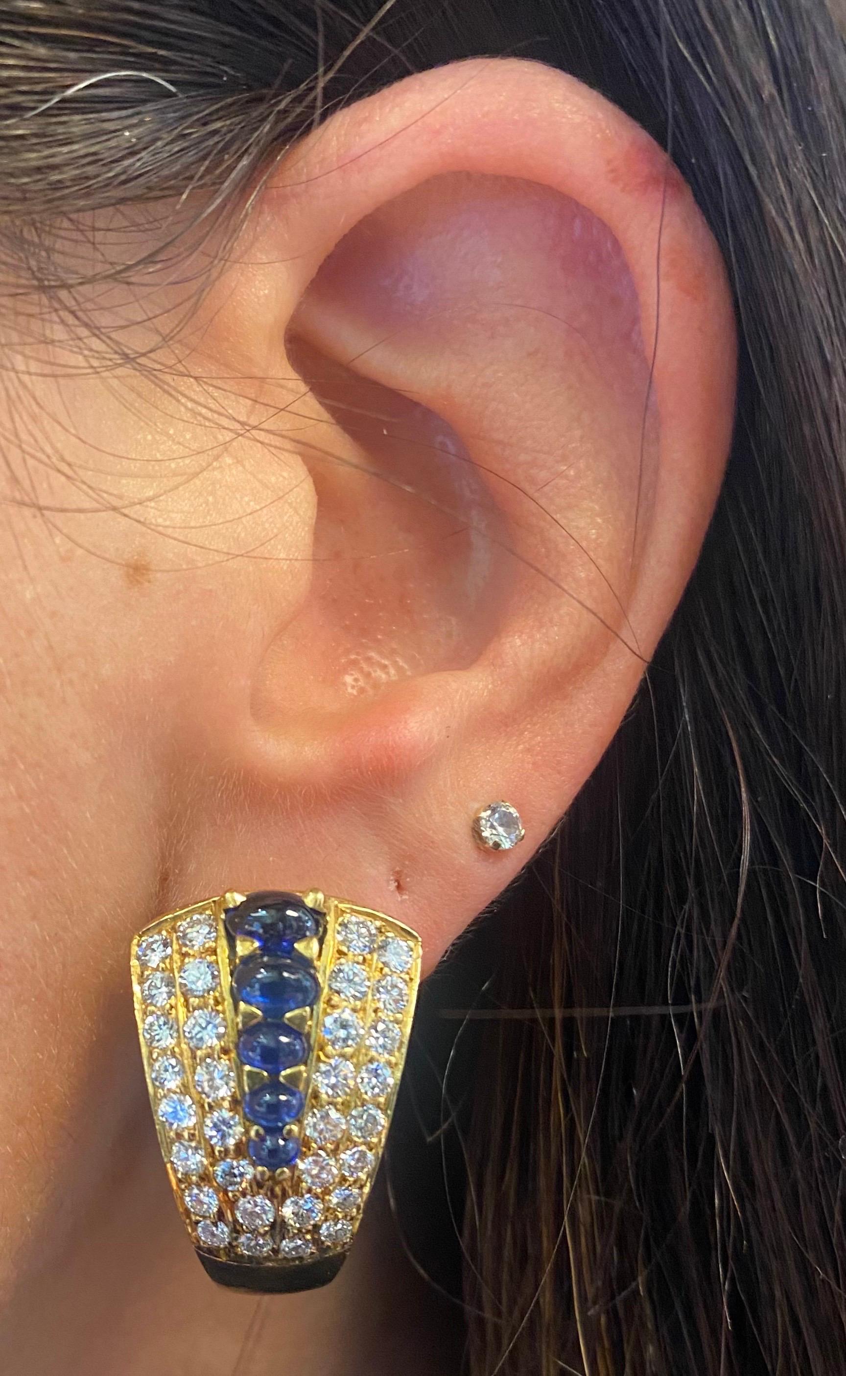Sapphire and Diamond Earrings 

A pair of clip-on earrings set with 10 cabochon sapphires and 64 round-cut diamonds. 

Approximate Diamond Weight: 3.15 carats
Approximate Sapphire Weight: 2.55 carats
Approximately Measures 1