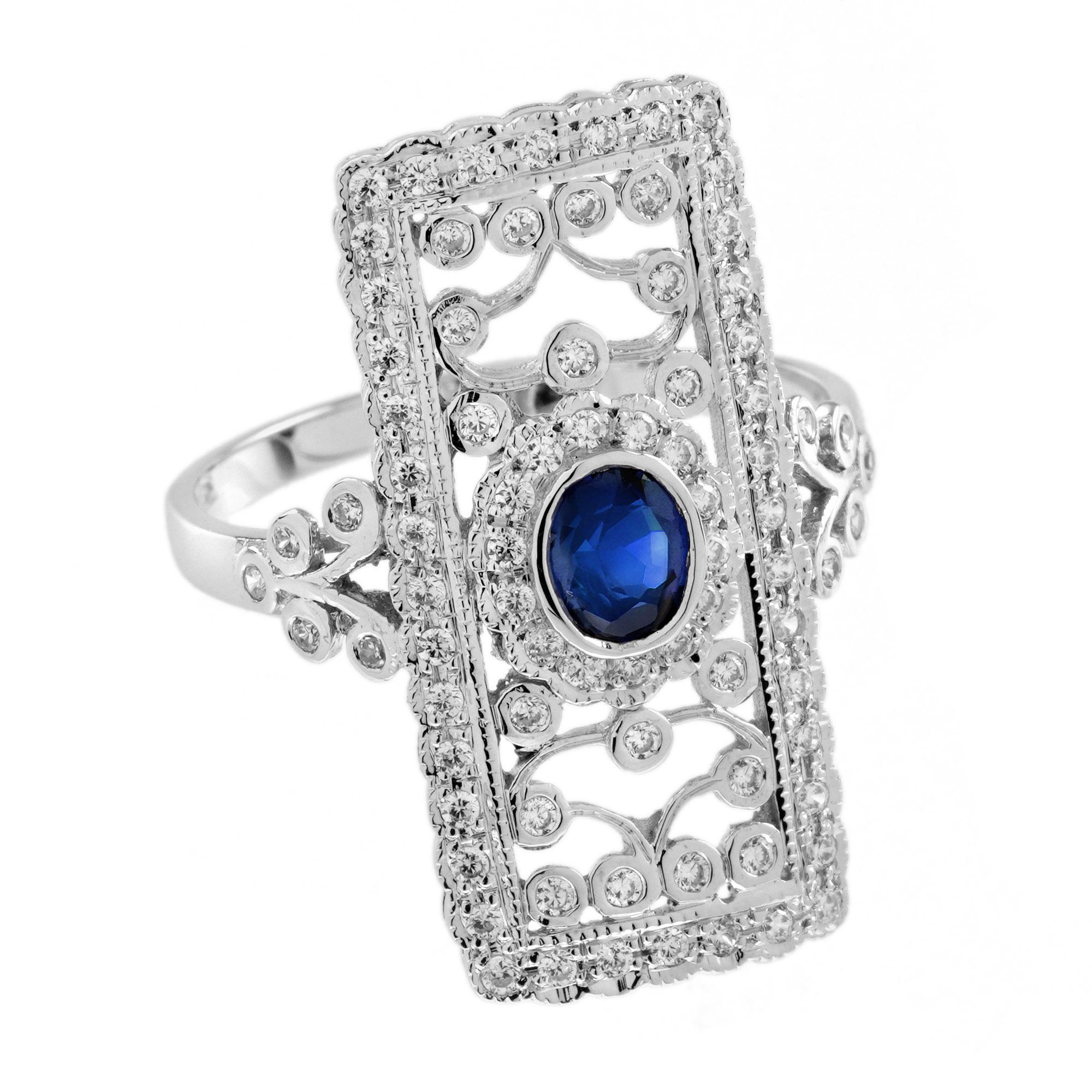 Make a bold statement with this Sapphire and Diamond Art Deco Style Floral Motif Dinner Ring. Featuring a vibrant oval sapphire at the center, the ring is surrounded by sparkling diamonds in a refined open-work rectangular layout. With its clean