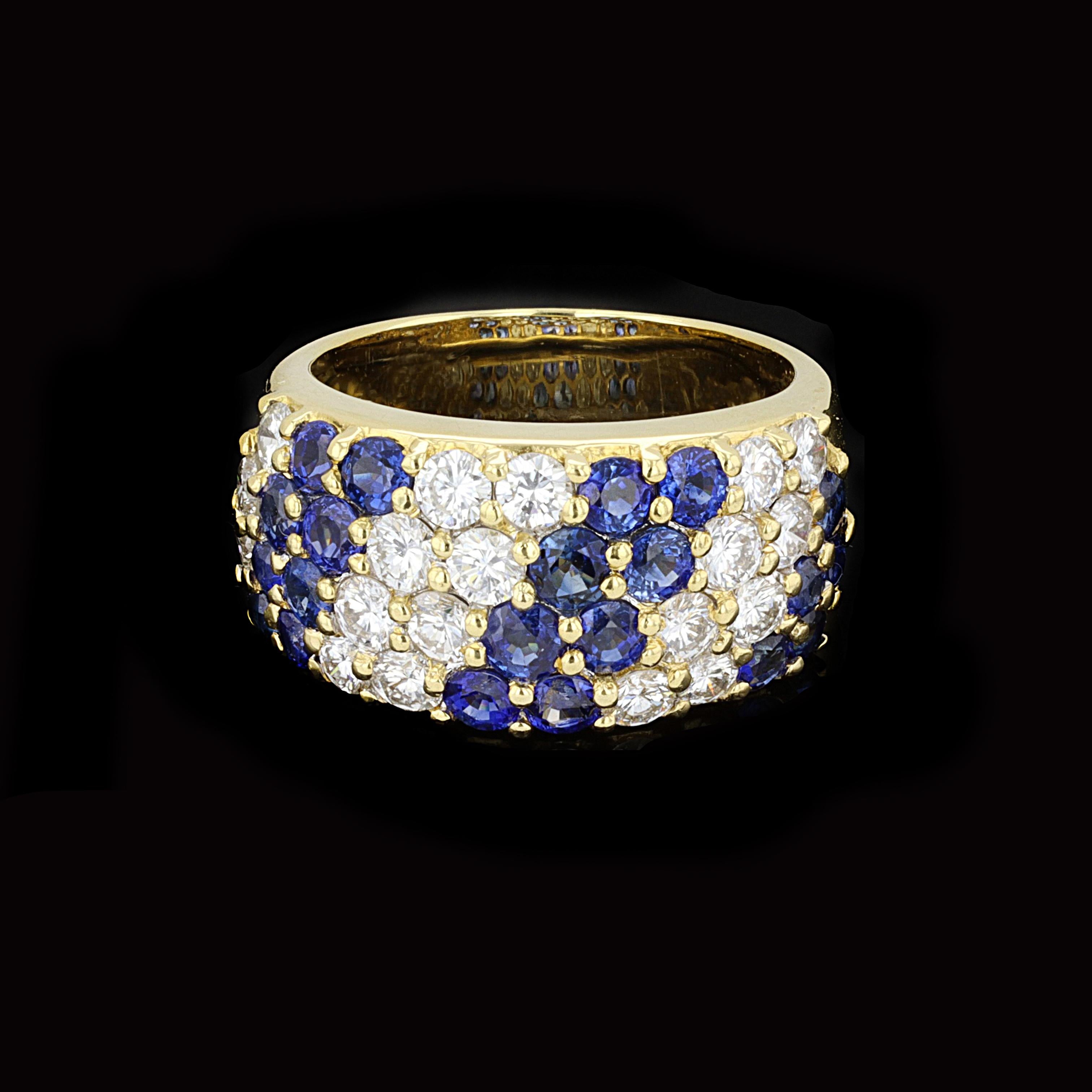 Brilliant diamonds pair with gloriously rich sapphires in a double row striped pattern to make this sophisticated 18K yellow gold estate ring pop with eye-catchng sparkle.The low profile ring is set with round cut sapphires and diamonds that weigh