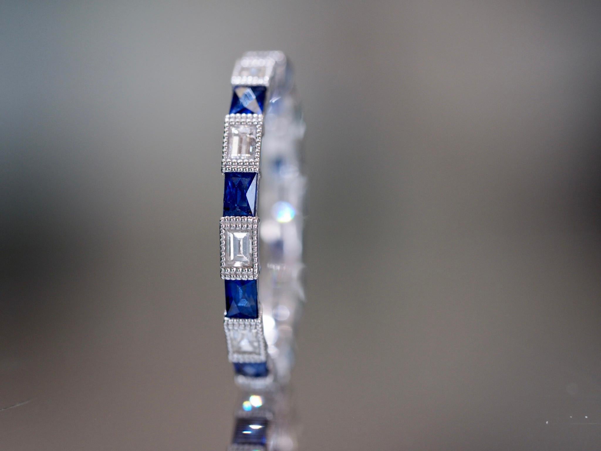 This brand new custom designed diamond and sapphire eternity band has been crafted to perfection. It consist of ten (10) emerald cut diamonds weighing 0.55 carats ranging from VS- SI clarity and F-G in color. They are individually set with a