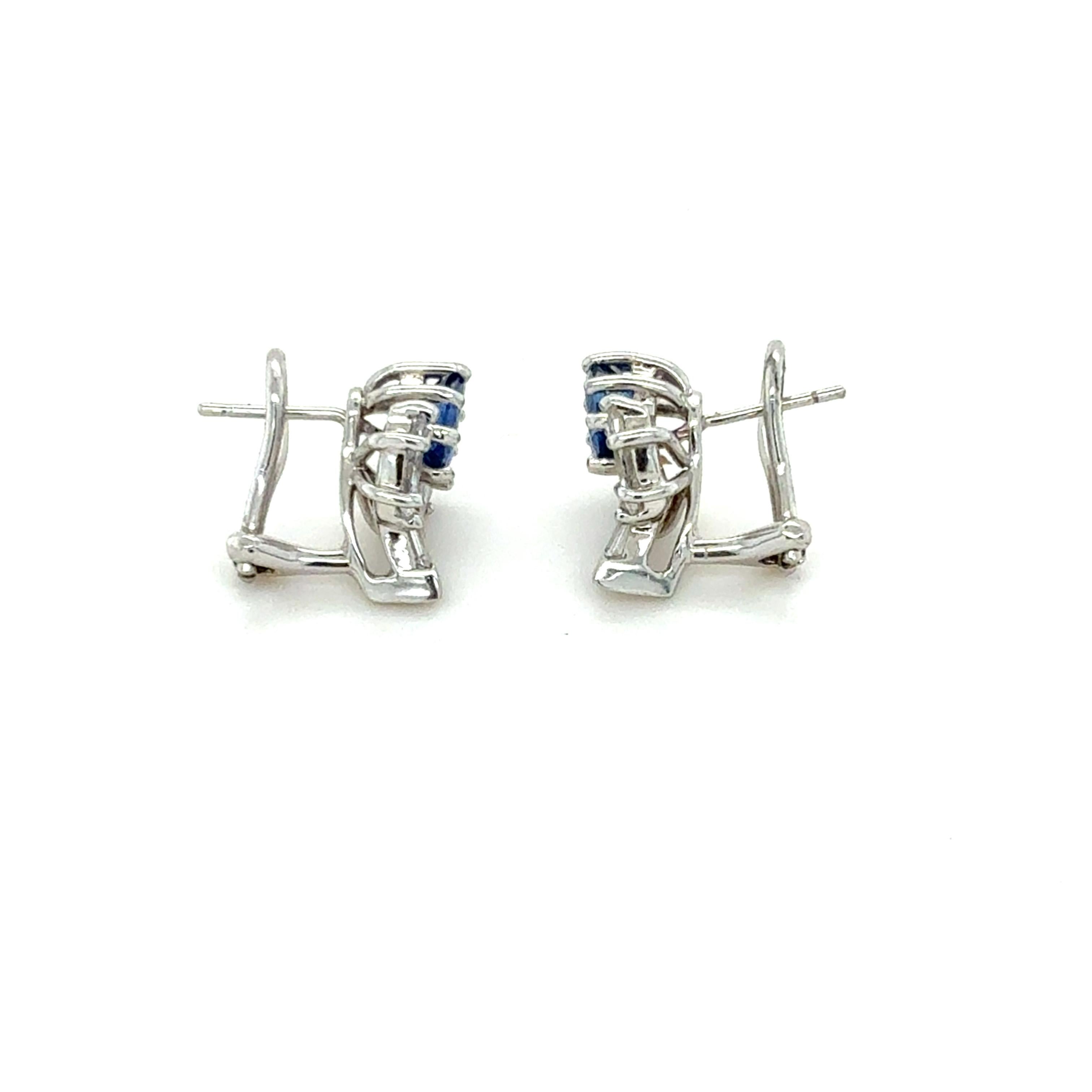 These classic sparkly earrings contain two oval sapphires weighing approximately 2.80 carats total, four marquise and two tapered baguette cut diamonds weighing approximately 1.50 carats total. Mounted in 18 karat white gold and beautifully made,