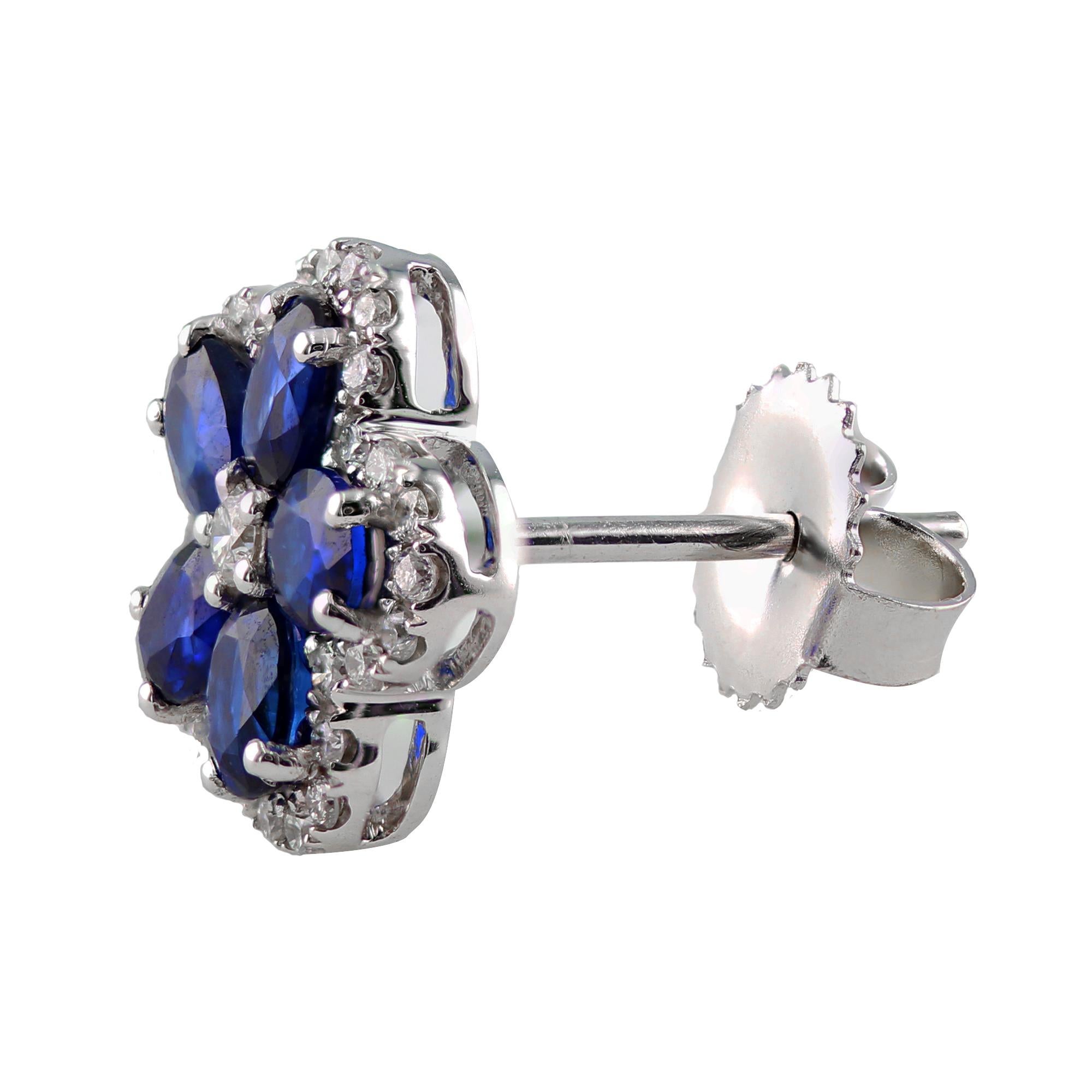 These stylish earrings features 10 oval Sapphires, 2.20 carat total weight.

Surrounded by round diamonds, with a round diamond center, 0.45 carat total weight.

Set in 18K.

A pair of beautiful and elegant Sapphire earrings, fit for any occasion.
