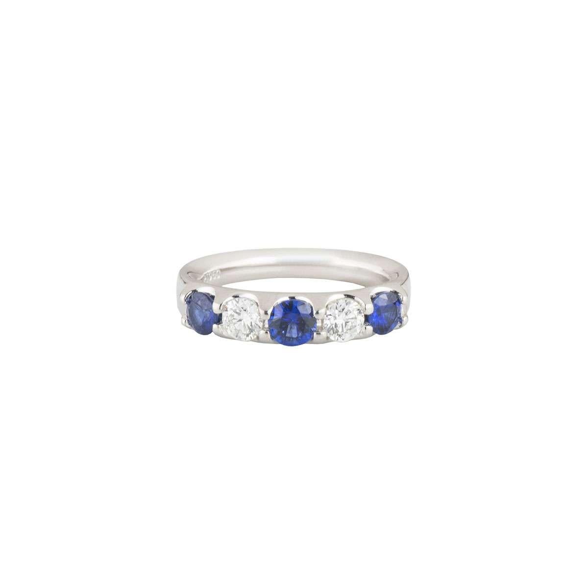A sapphire and diamond half eternity ring in platinum. The ring is set to the front with 3 sapphires and 2 diamonds, both round brilliant cut and in a shared setting. The sapphires have a total weight of approximately 0.51ct and the diamonds total