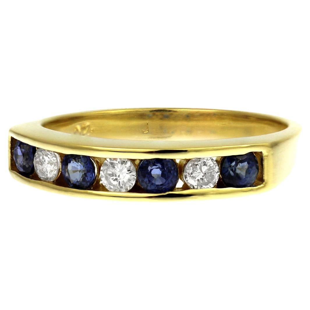 Sapphire and diamond half eternity channel set ring in 18ct yellow gold For Sale