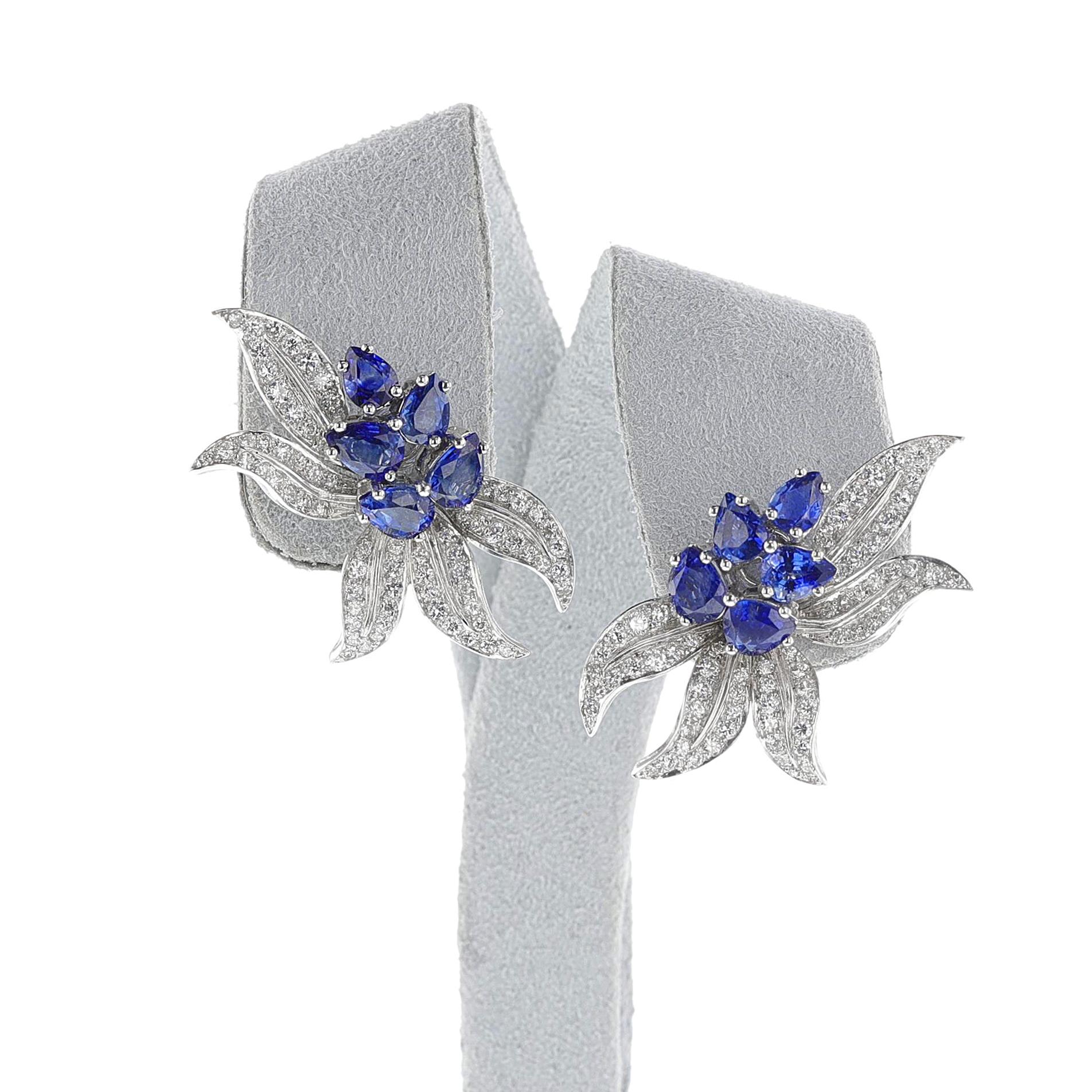 An artistic pair of Sapphire and Diamond Half-Flower Earrings made in 18k White Gold. The center has pear-shaped sapphires with brilliant-cut diamonds. French import marks. The measurements are 1.40 inches x 0.78 inches. The total weight is 14.74