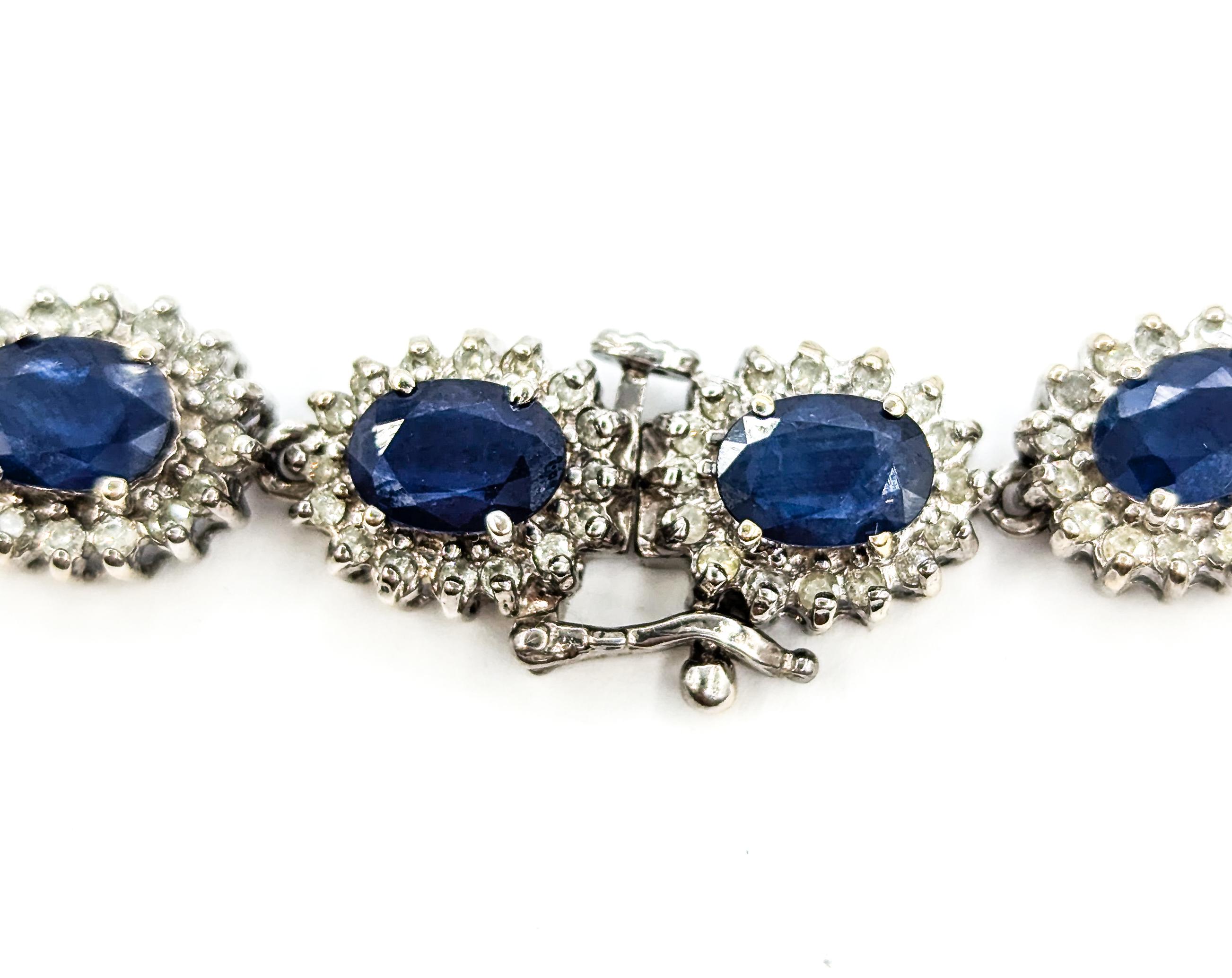 Sapphire and Diamond Halo Bracelet in White Gold

Introducing this exquisite Sapphire & Diamond bracelet, crafted in 14k white gold. The bracelet features an impressive 13.84ctw of deep blue sapphires, beautifully complemented by 3.25ctw of
