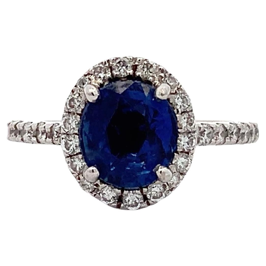 Sapphire and diamond halo engagement ring 18k white gold