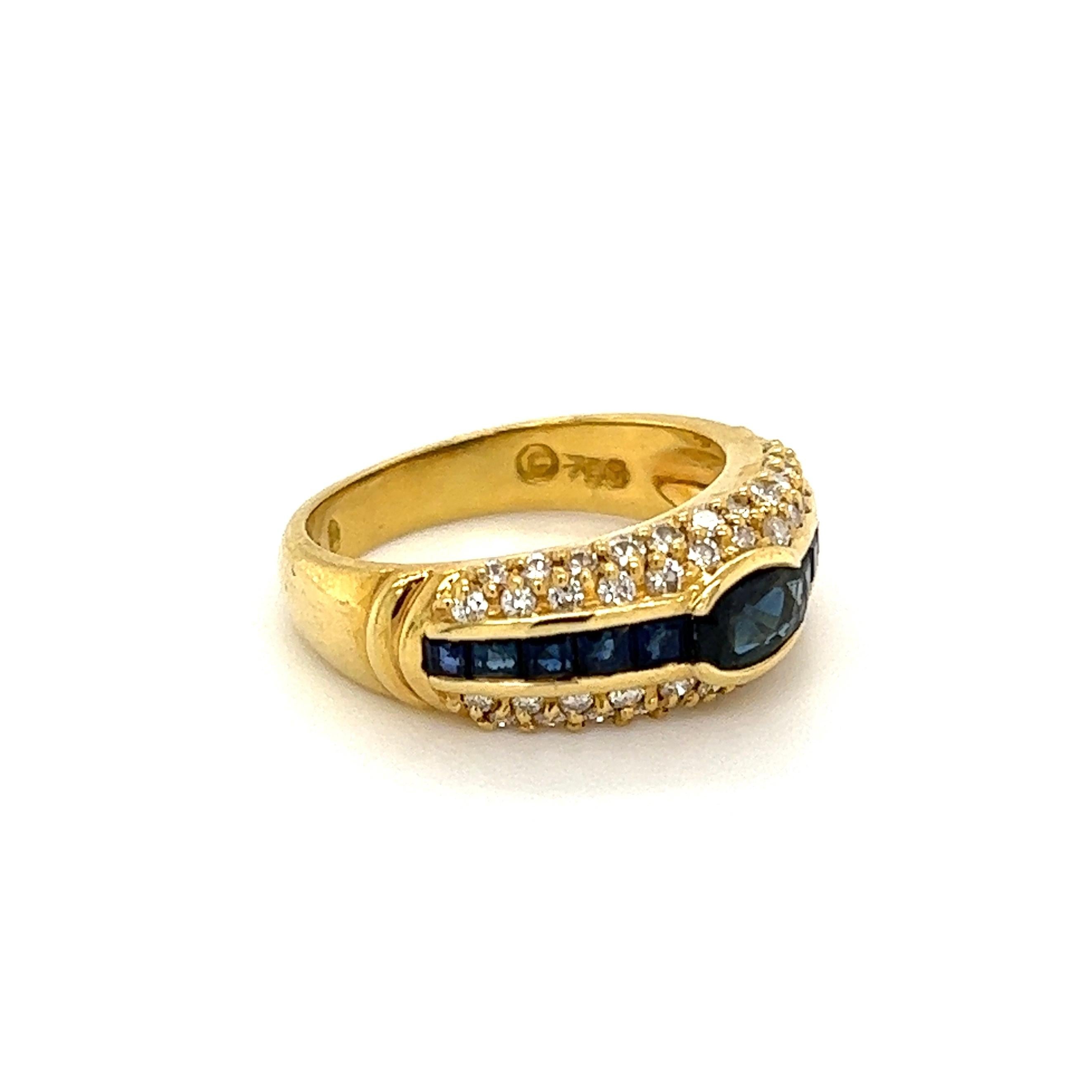 Beautiful and Stylish Sapphire and Diamond Gold Band Ring. Center securely Hand set with Sapphires, weighing approx. 1.1tcw, surrounded by Diamonds weighing approx. 0.31tcw. Hand crafted in 18K Yellow Gold. Measuring approx. 0.87” l x 0.73” w x