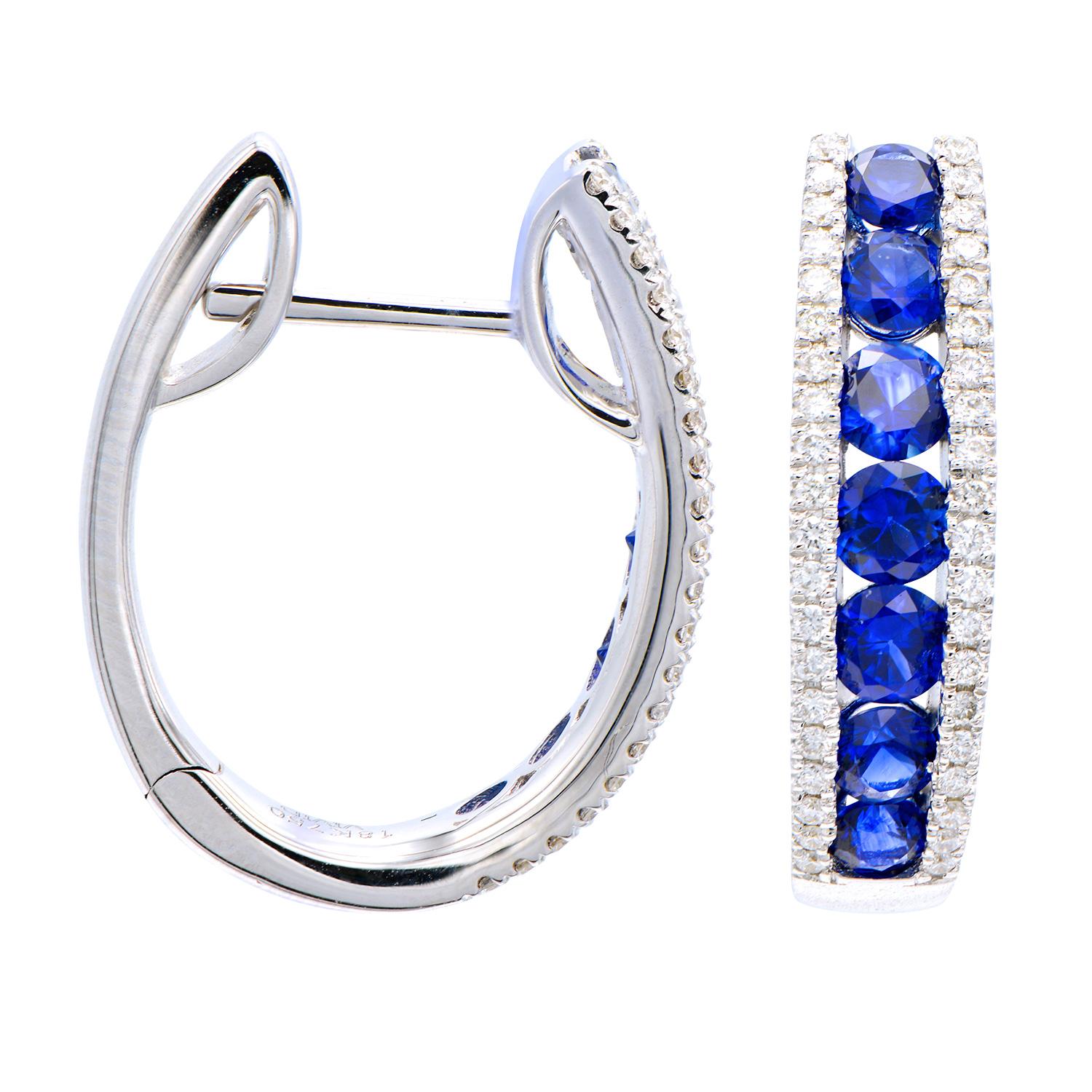 These beautiful Sapphire and Diamond hoops are a classic staple and a change from regular diamonds. These earrings contain 14 royal blue sapphires totaling 1.59 carats and are surrounded by 80 round VS2, G color diamonds totaling 0.28 carats. The