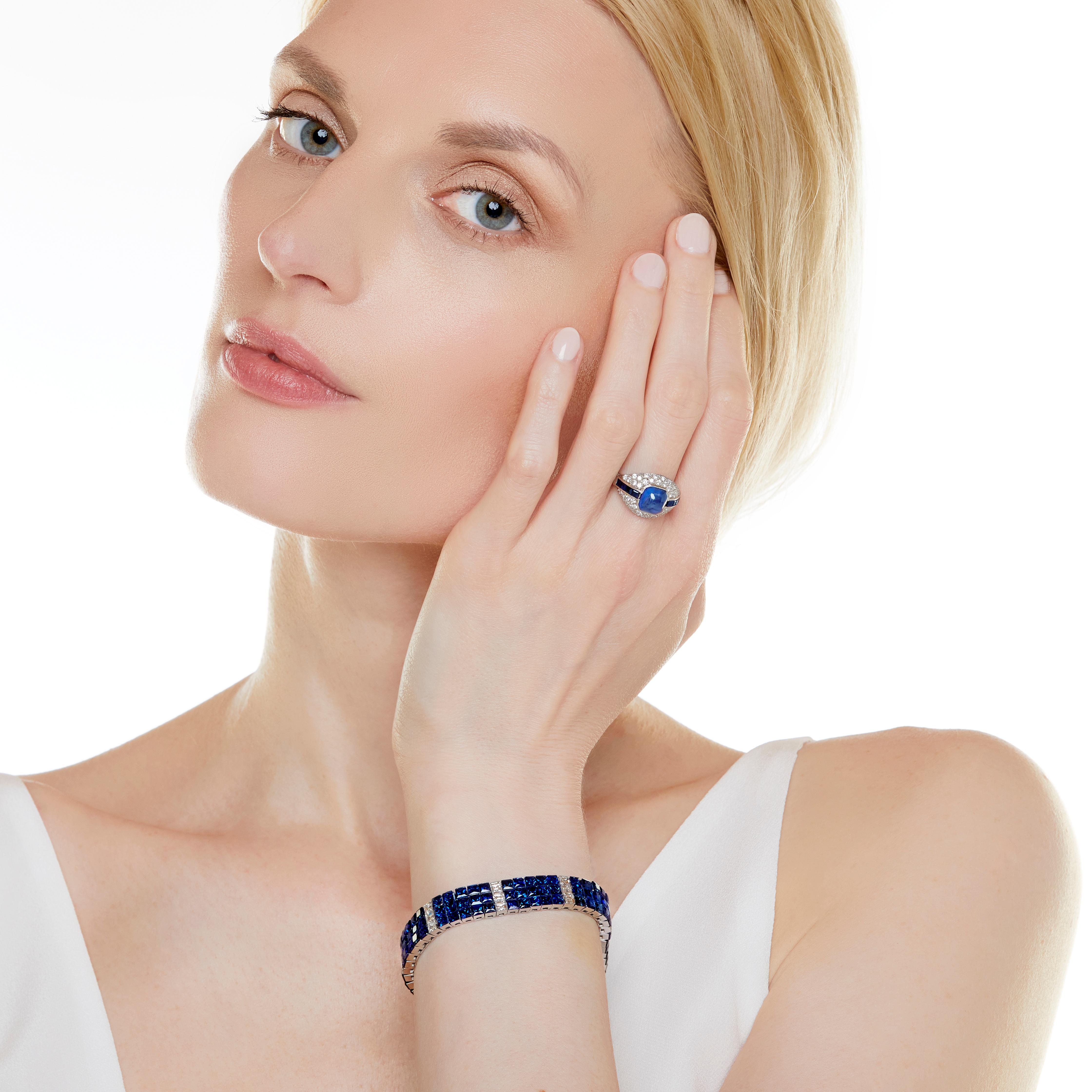 This sophisticated invisibly set sapphire and diamond bracelet is as flexible and easy to wear as a ribbon tied around your wrist. Set in platinum, the square cut sapphires are set in panels of fifteen stones interspersed with three French-cut